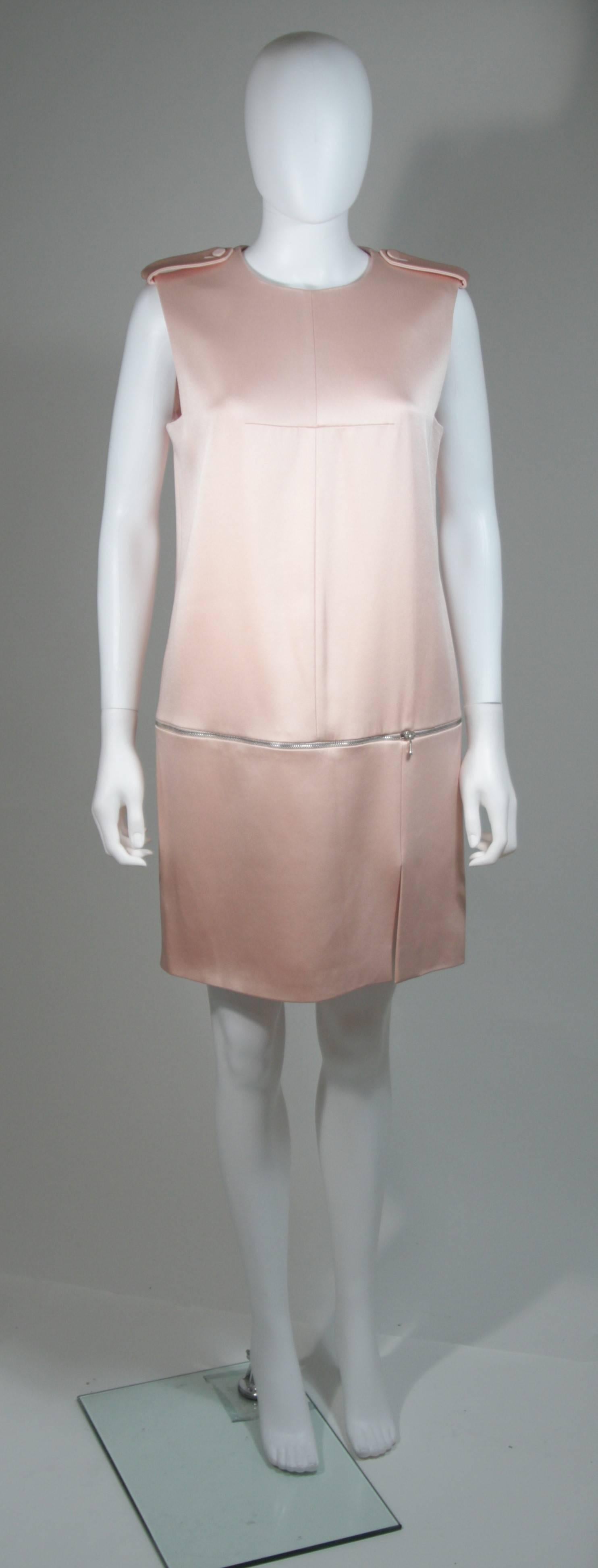 This Alexander McQueen dress is composed of a pink silk. Features a functional zipper detail at the hips and shoulder details. There is a center back zipper closure. In excellent condition, possibly unworn. 

**Please cross-reference measurements
