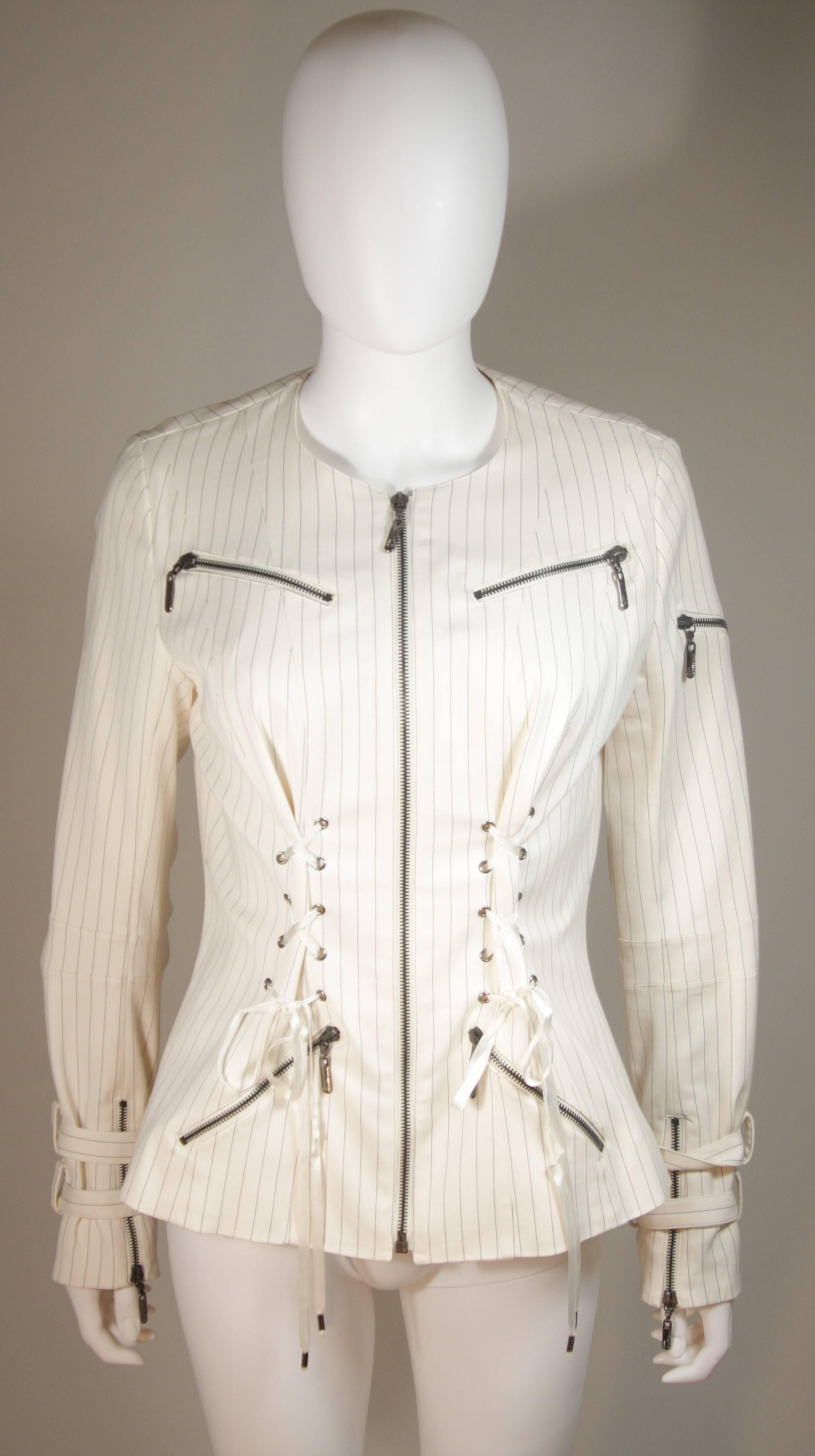 This John Galliano design is available for viewing at our Beverly Hills Boutique. We offer a large selection of evening gowns and luxury garments. 

 This jacket is composed of a cream and black pinstripe. Features zipper details with corseting at