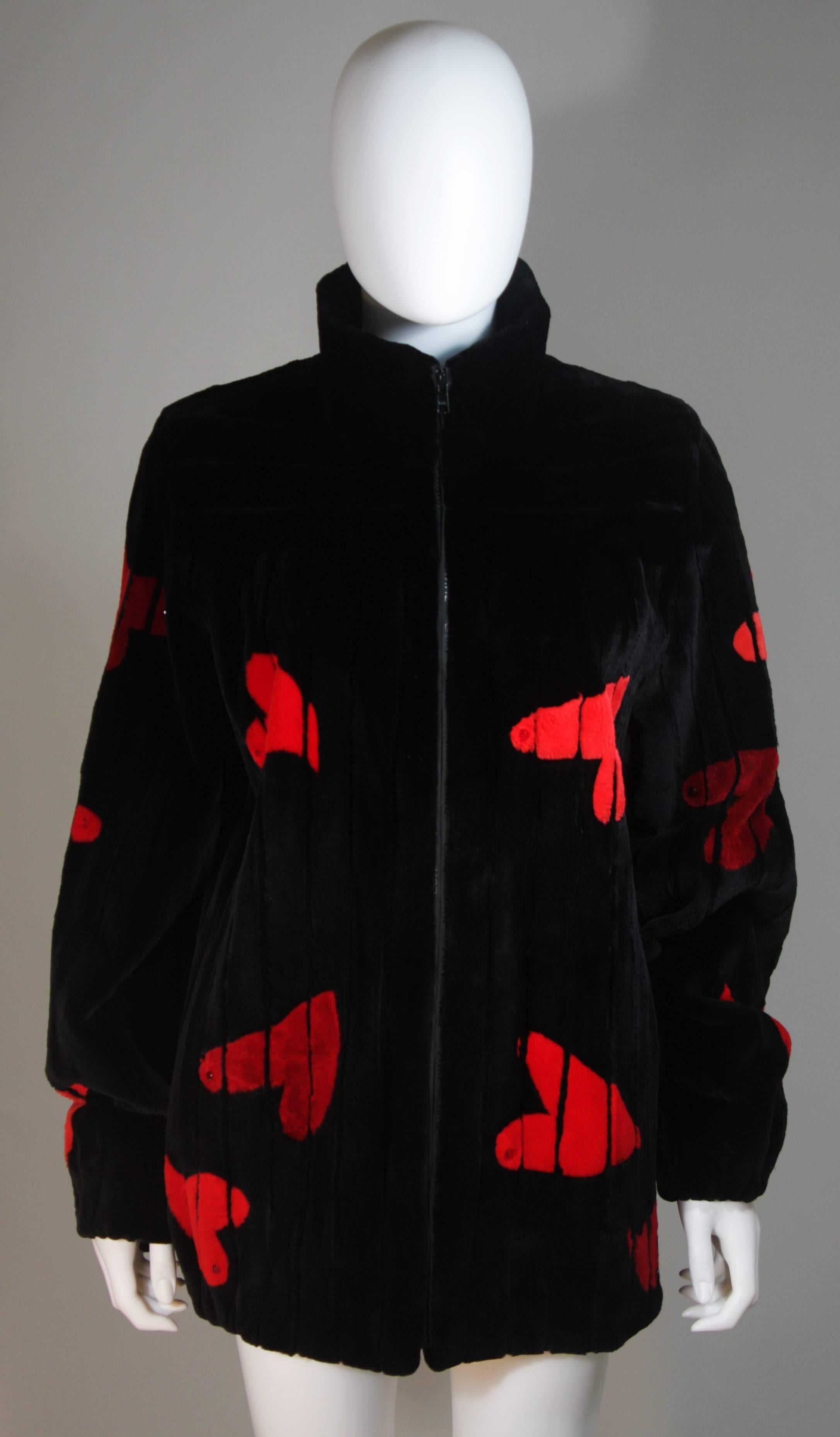 This Beautifully Canadian Zuki coat is composed of a striking color infused sheared beaver. The ultra soft coat features a black and red hearts motif. There is a center front zipper closure. There are velvet lined side pockets and a perfect collar.