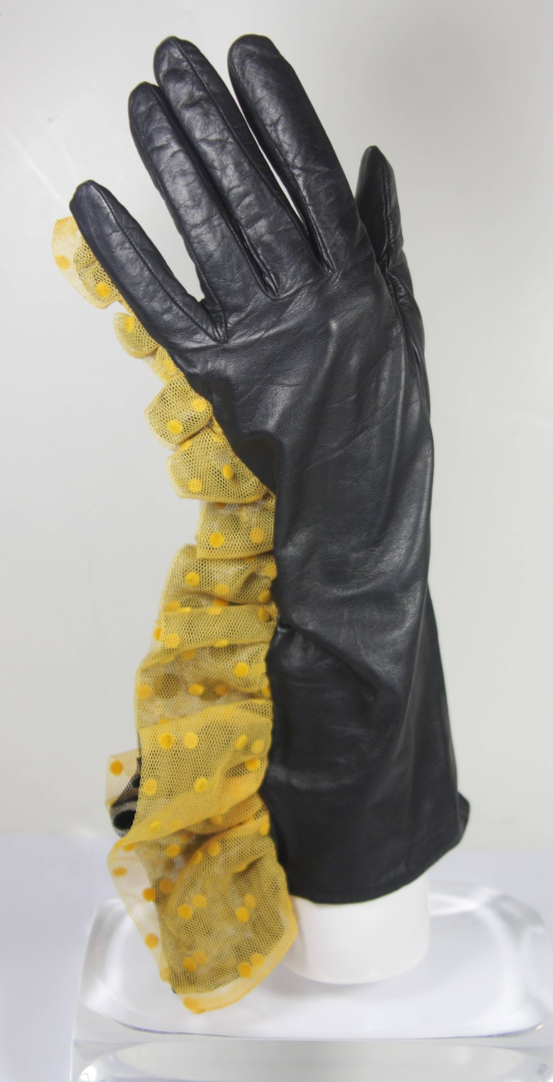 This vintage design is available for viewing at our Beverly Hills Boutique. We offer a large selection of evening gowns and luxury garments. 

 This gloves are composed of an ultra soft leather and feature a yellow with black polka dot mesh