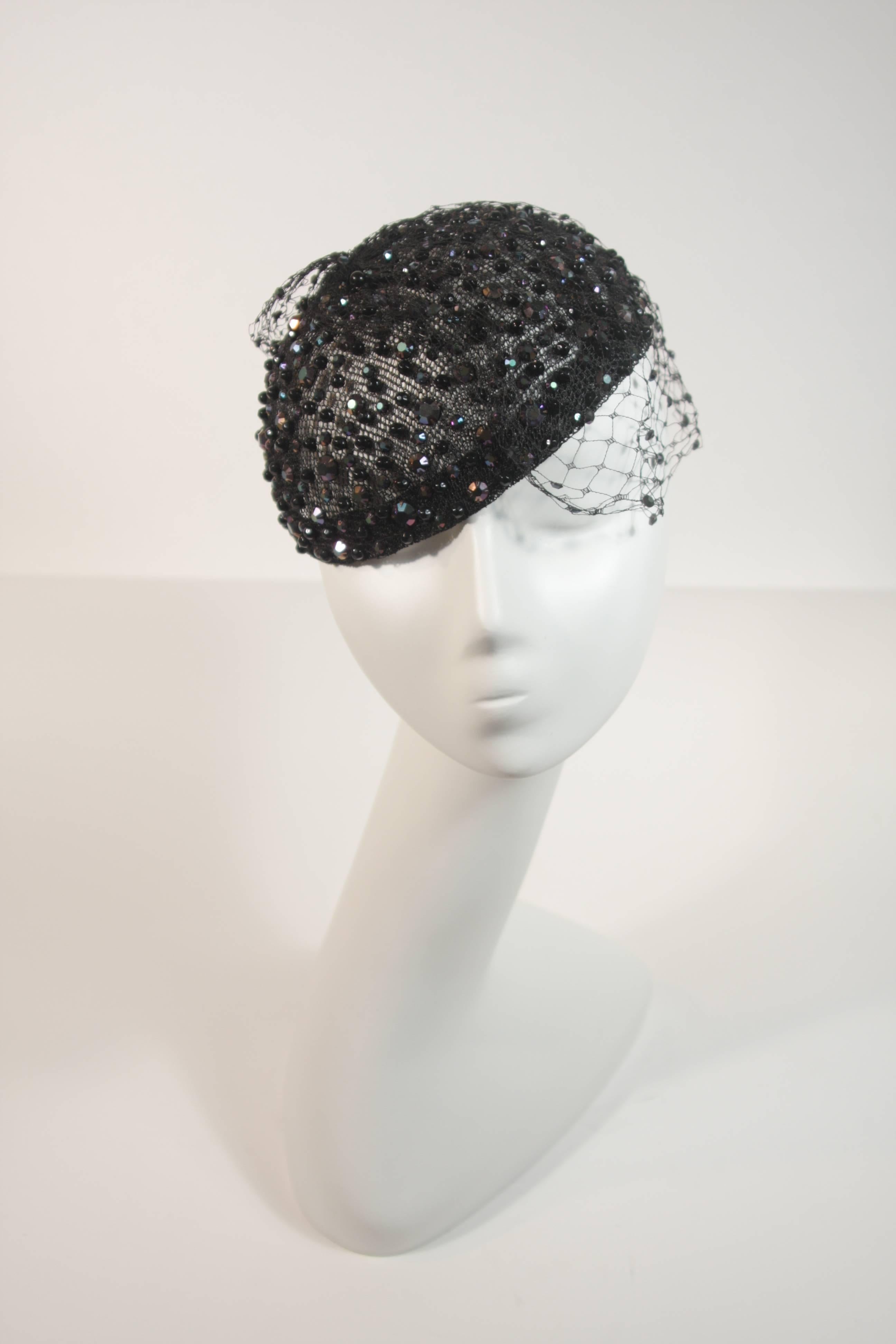 This Frank Olive hat is composed of a black mesh, with netting, and features rhinestones throughout. In excellent condition.

  **Please cross-reference measurements for personal accuracy. 

Measurements (Approximately)  
Circumference: