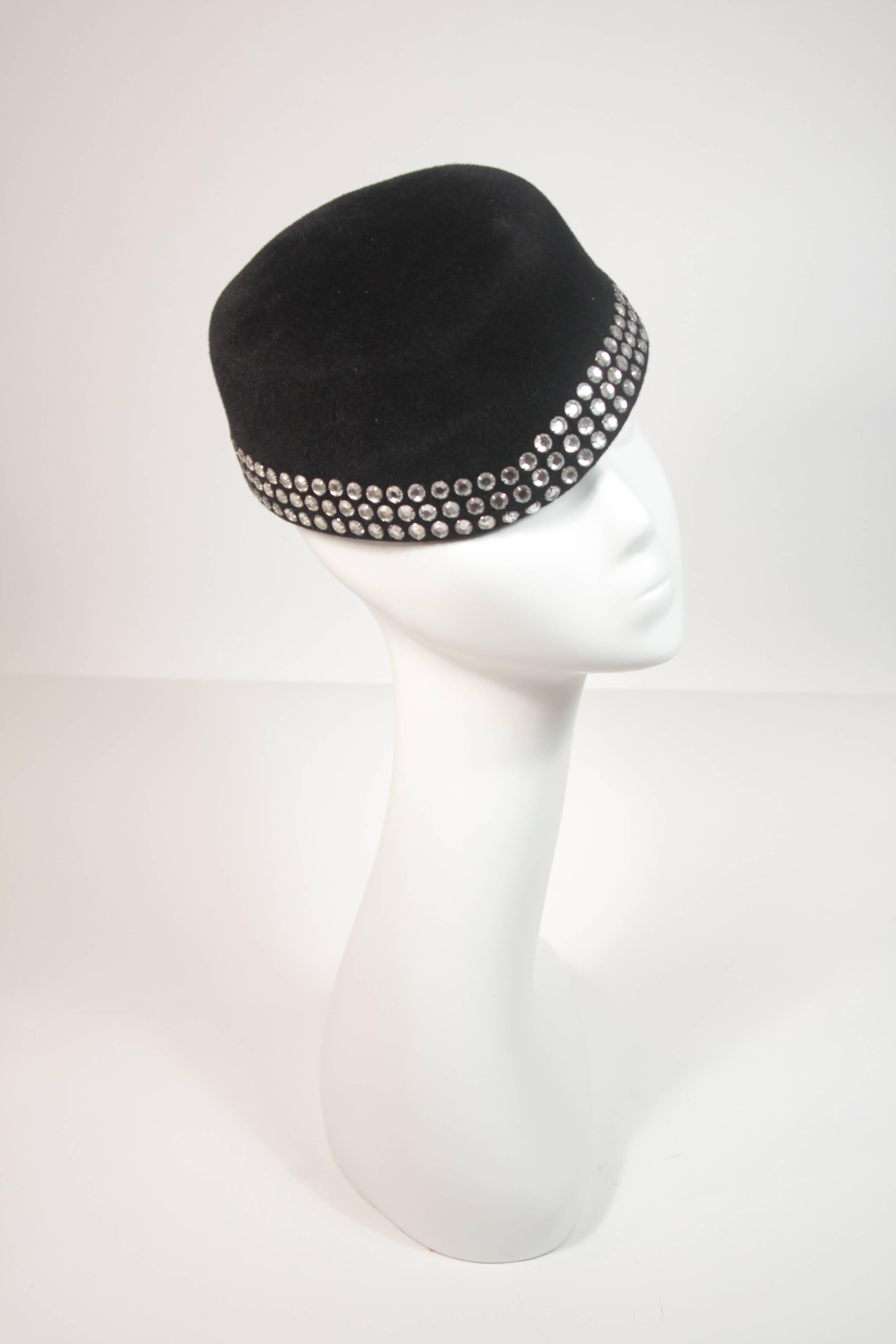 This Frank Olive hat is composed of a black velour and features three rhinestones rows. There are two combs for security. In excellent condition.

  **Please cross-reference measurements for personal accuracy. 

Measurements (Approximately) 