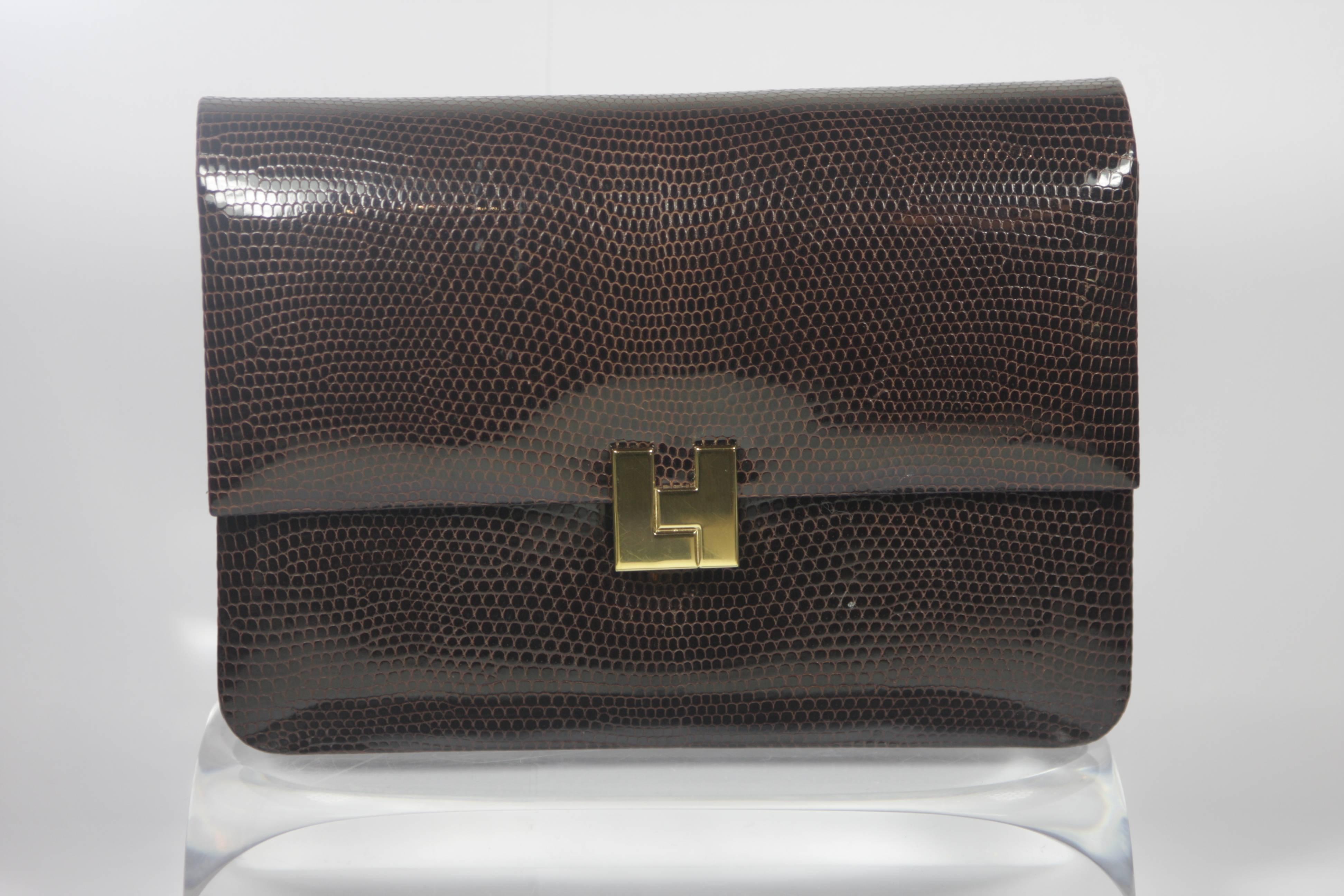 This Lambertson  purse is composed of a brown lizard, features gold hardware, and a bright blue leather interior. Features an optional strap in original plastic. In excellent unused vintage condition.

  **Please cross-reference measurements for