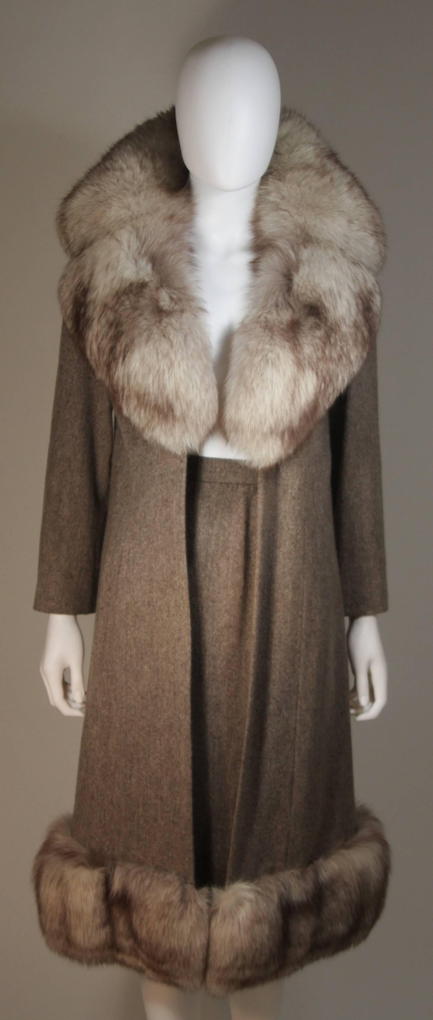 This Nolan Miller set is composed of a brown/oatmeal combination wool and features fox fur trim. The jacket has a center front hook and eye closure. The skirt features a draped design with zipper closure. In excellent condition.

  **Please