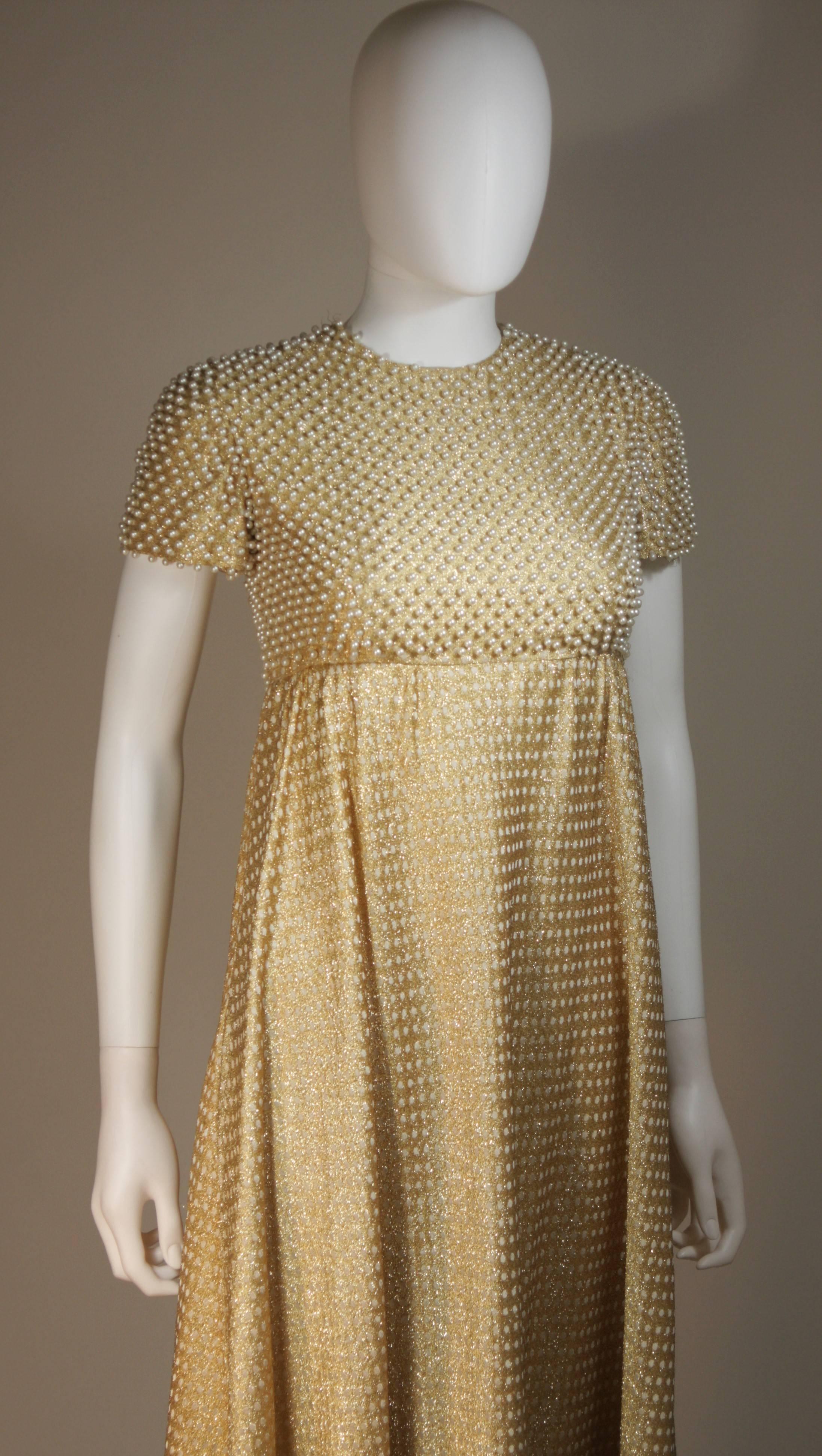 evening dress in copper-toned gold lame with belt and attached necklaces