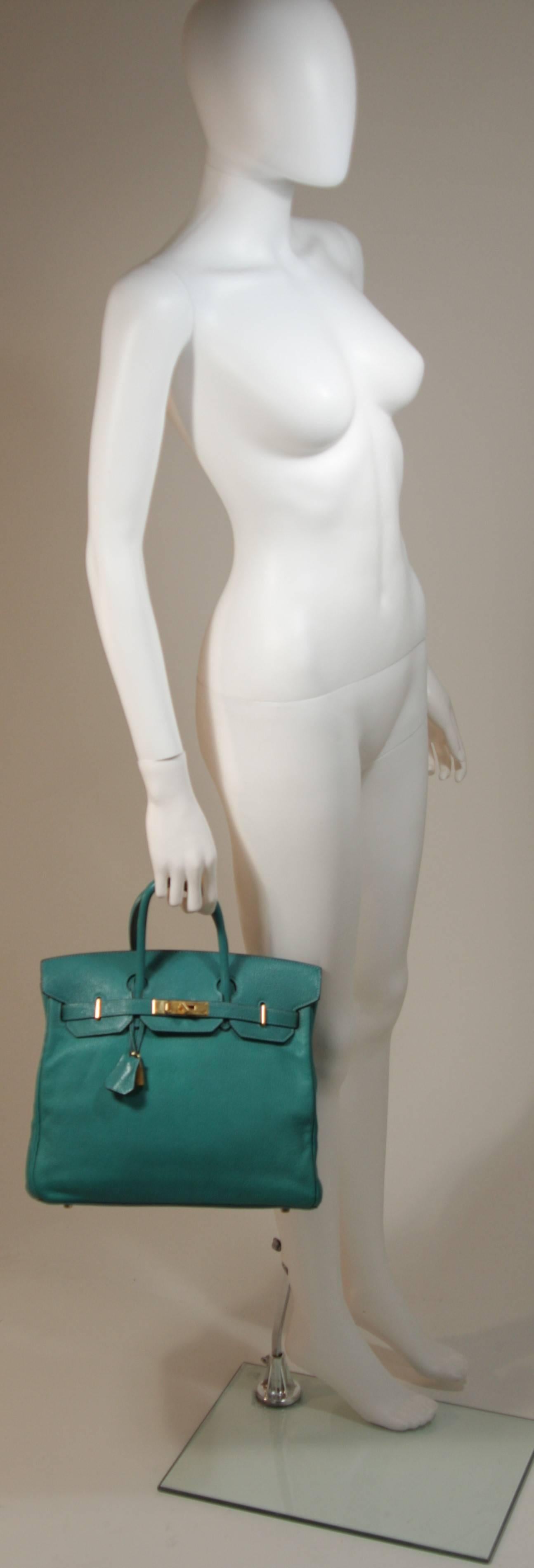 This Hermes design is available for viewing at our Beverly Hills Boutique. We offer a large selection of evening gowns and luxury garments. 

 This Hermes purse is composed of an ultra supple teal hued leather. Features the classic Birkin design