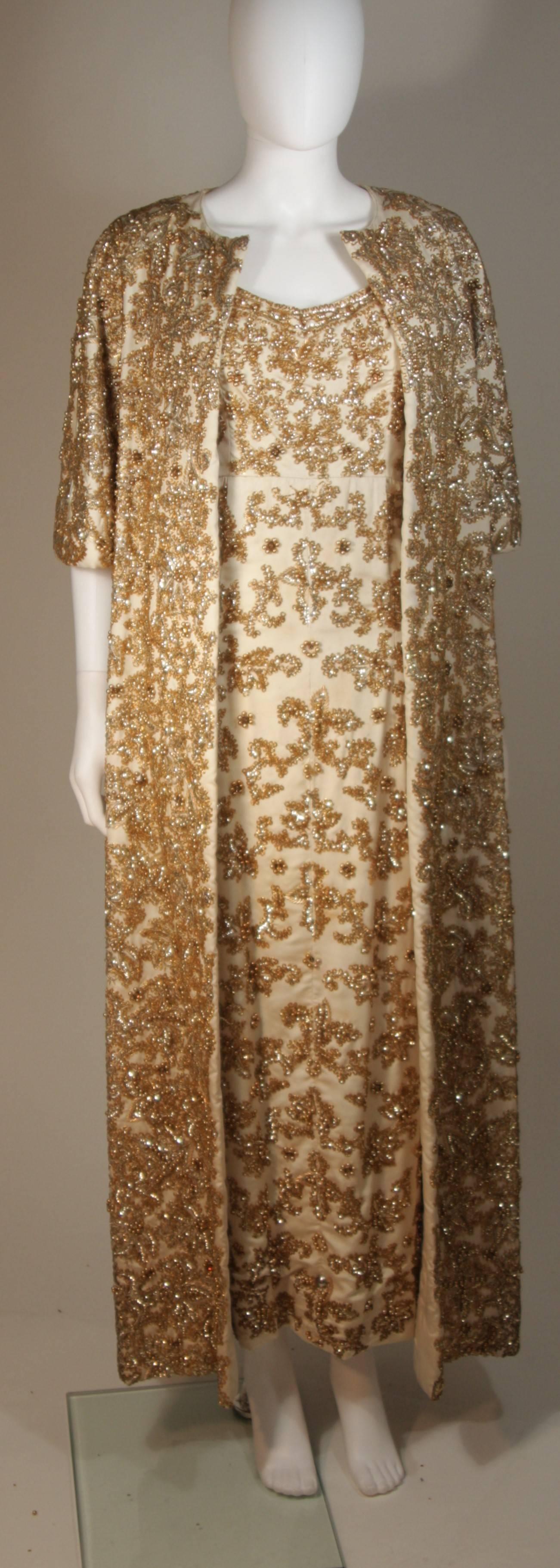This Samuel Winston design is available for viewing at our Beverly Hills Boutique. We offer a large selection of evening gowns and luxury garments. 

 This ensemble is composed of a heavily beaded silk in a gold and hue with floral motif. The gown