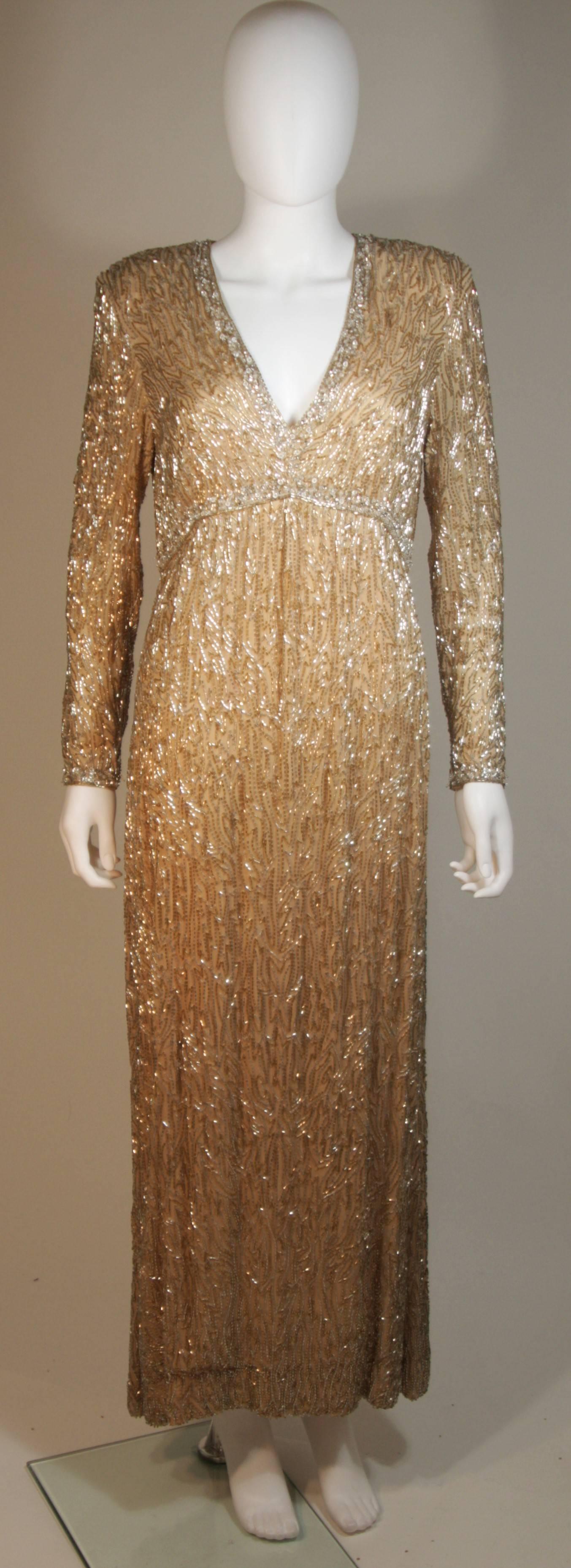 This Victoria Royal  gown is composed of a beaded silk in champagne hues with silver. The gown features a plunge style neckline and long sleeves. There is a center back zipper. In excellent vintage condition.

  **Please cross-reference