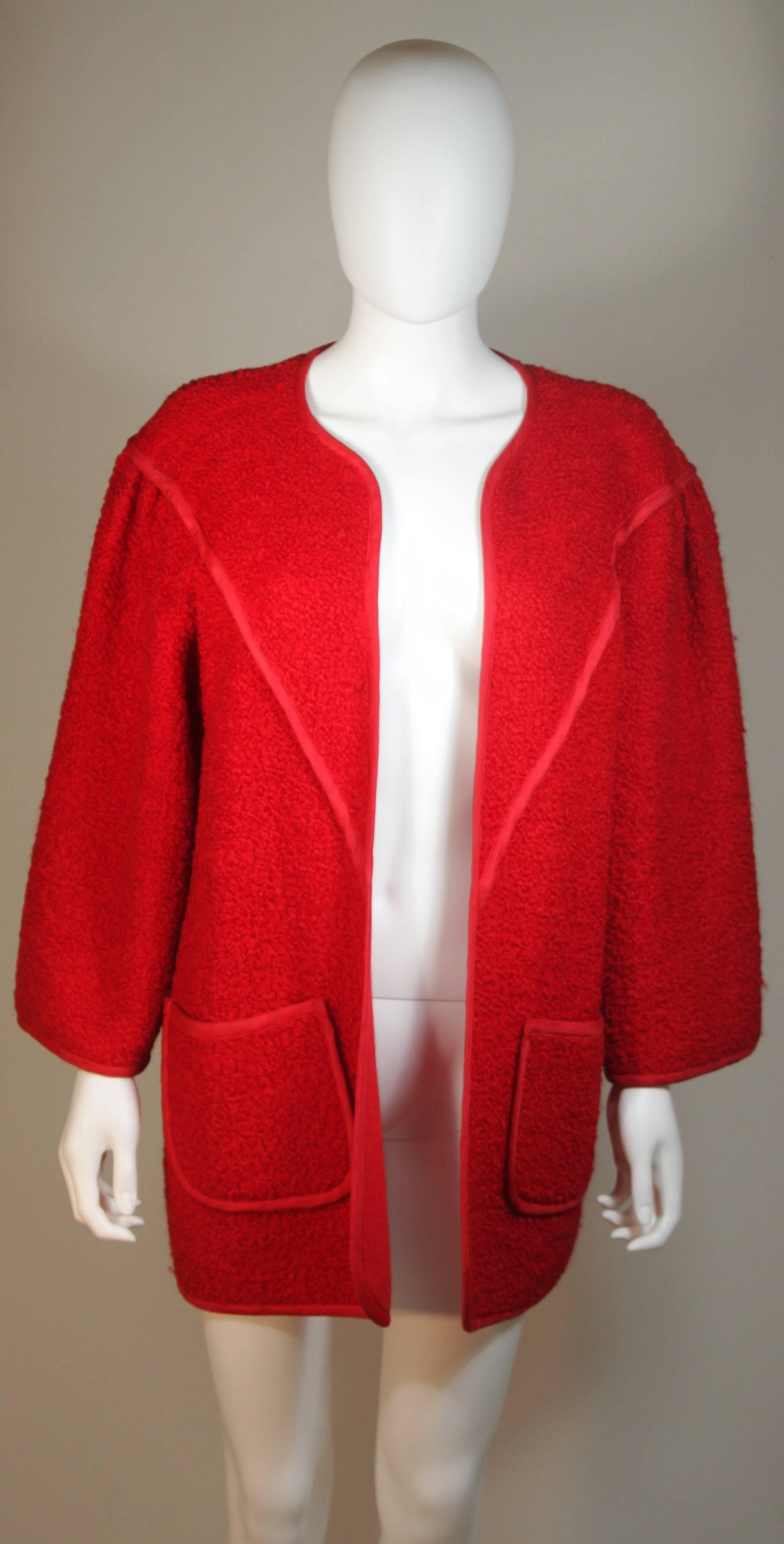 This Jean Muir  coat is composed of vibrant red wool. Features large front pockets and an open style design. In excellent condition. Made in England.

  **Please cross-reference measurements for personal accuracy. 

Measurements (Approximately) 