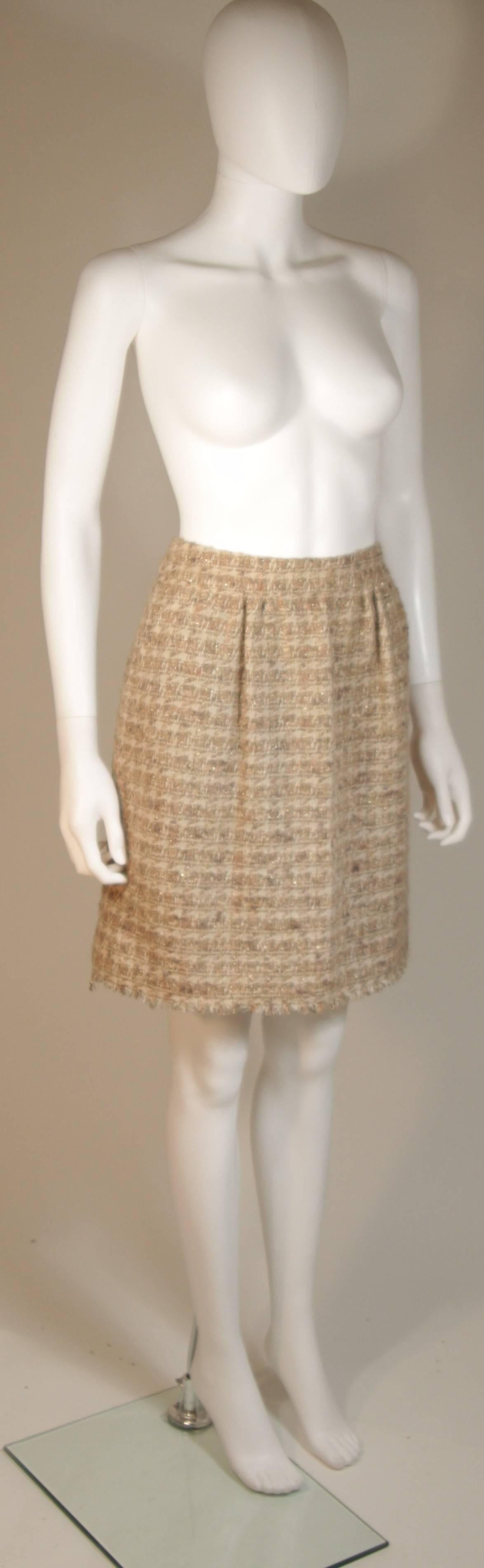 This Chanel design is available for viewing at our Beverly Hills Boutique. We offer a large selection of evening gowns and luxury garments. 

 This skirt is composed of a raw edged tweed in hues of brown and nude with metallic detailing. The skirt