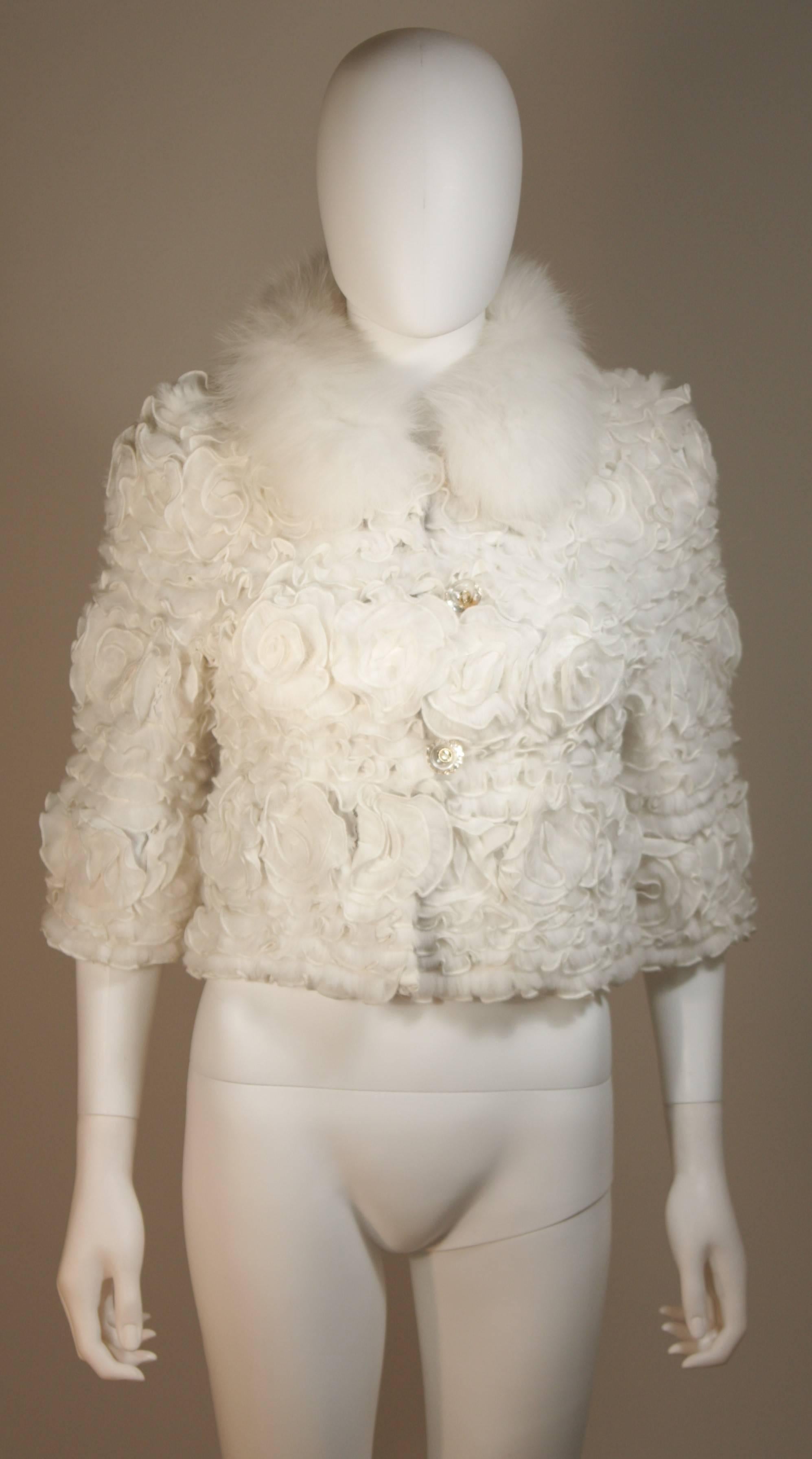 This  jacket if composed of white sheared material into floral motifs with fox fur. There are center front button closures and a satin lining. In excellent condition. Made in Canada

  **Please cross-reference measurements for personal accuracy.