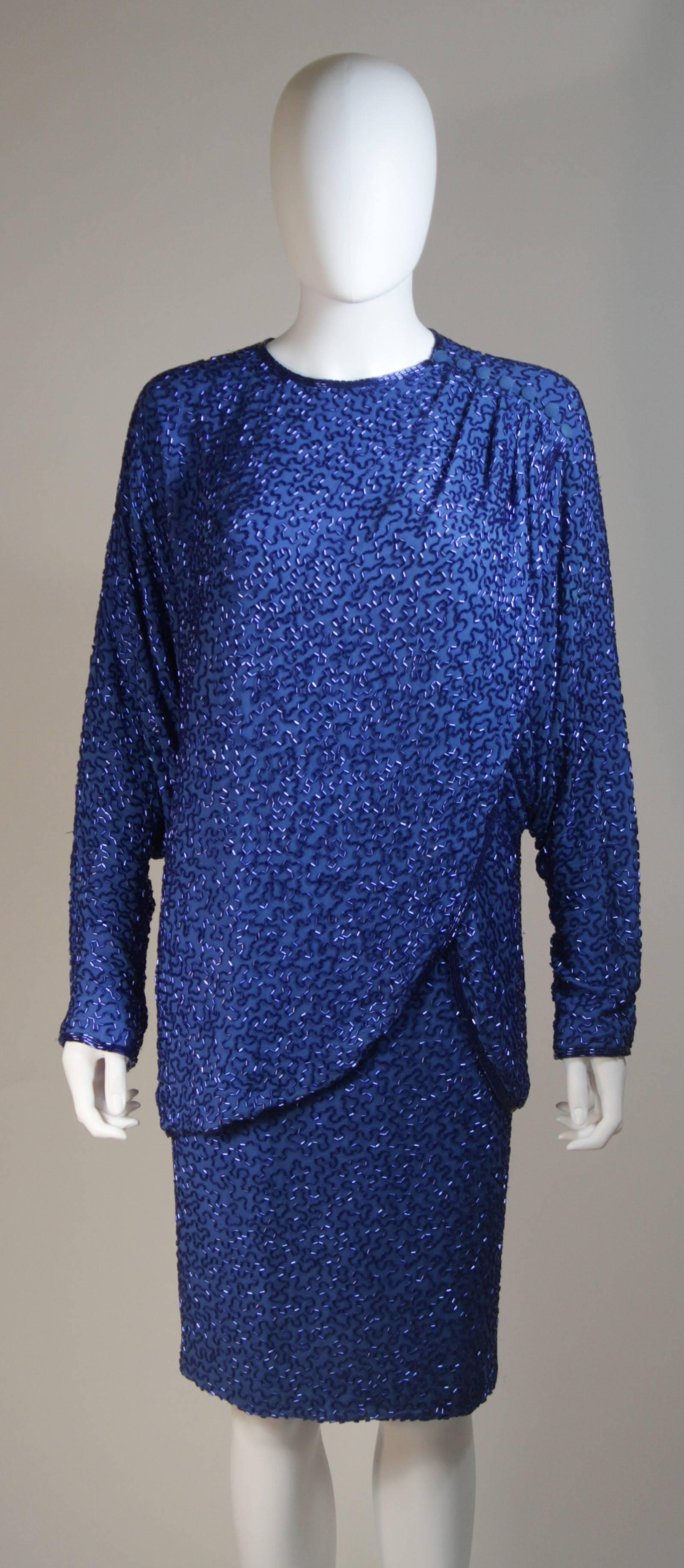 This Stephen Yearik skirt ensemble is composed of a beaded silk in a vibrant blue hue. The top has a draped design and closure at the shoulder. The skirt is a classic pencil silhouette with a zipper closure. In great vintage condition.

  **Please