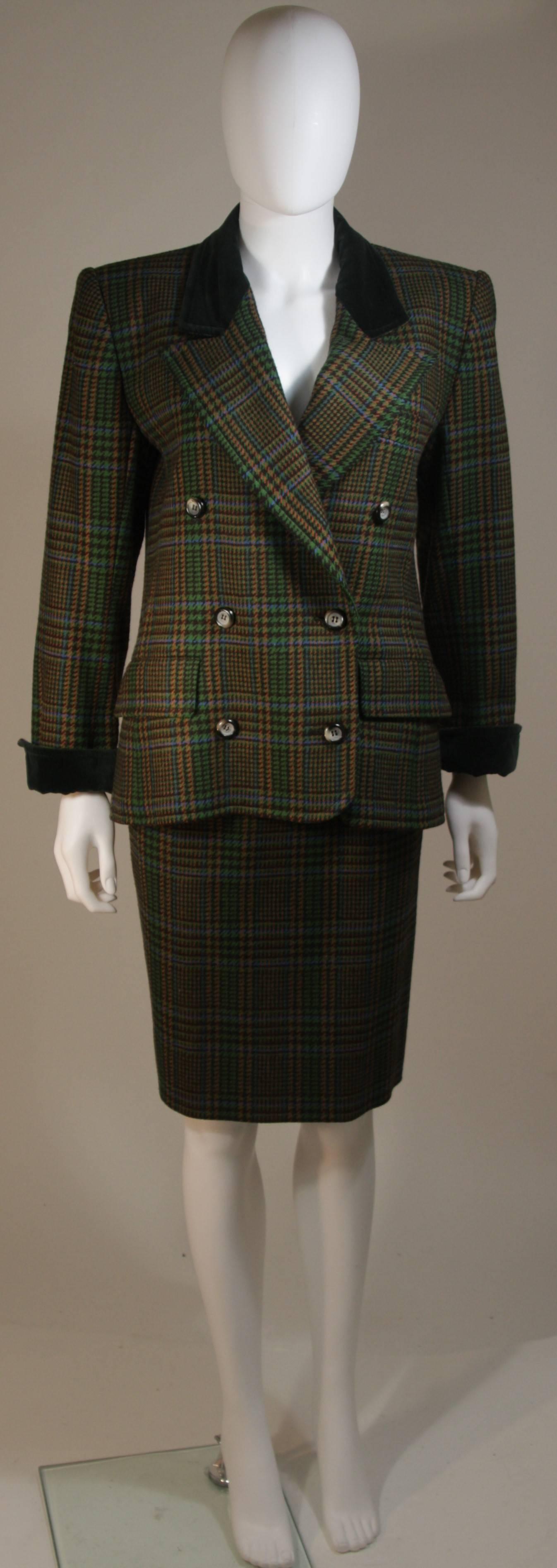 This Yves Saint Laurent skirt suit is composed of a green plaid wool and features velvet accents. The jacket has center front button closures. The skirt has a zipper closure. In excellent condition. 

  **Please cross-reference measurements for