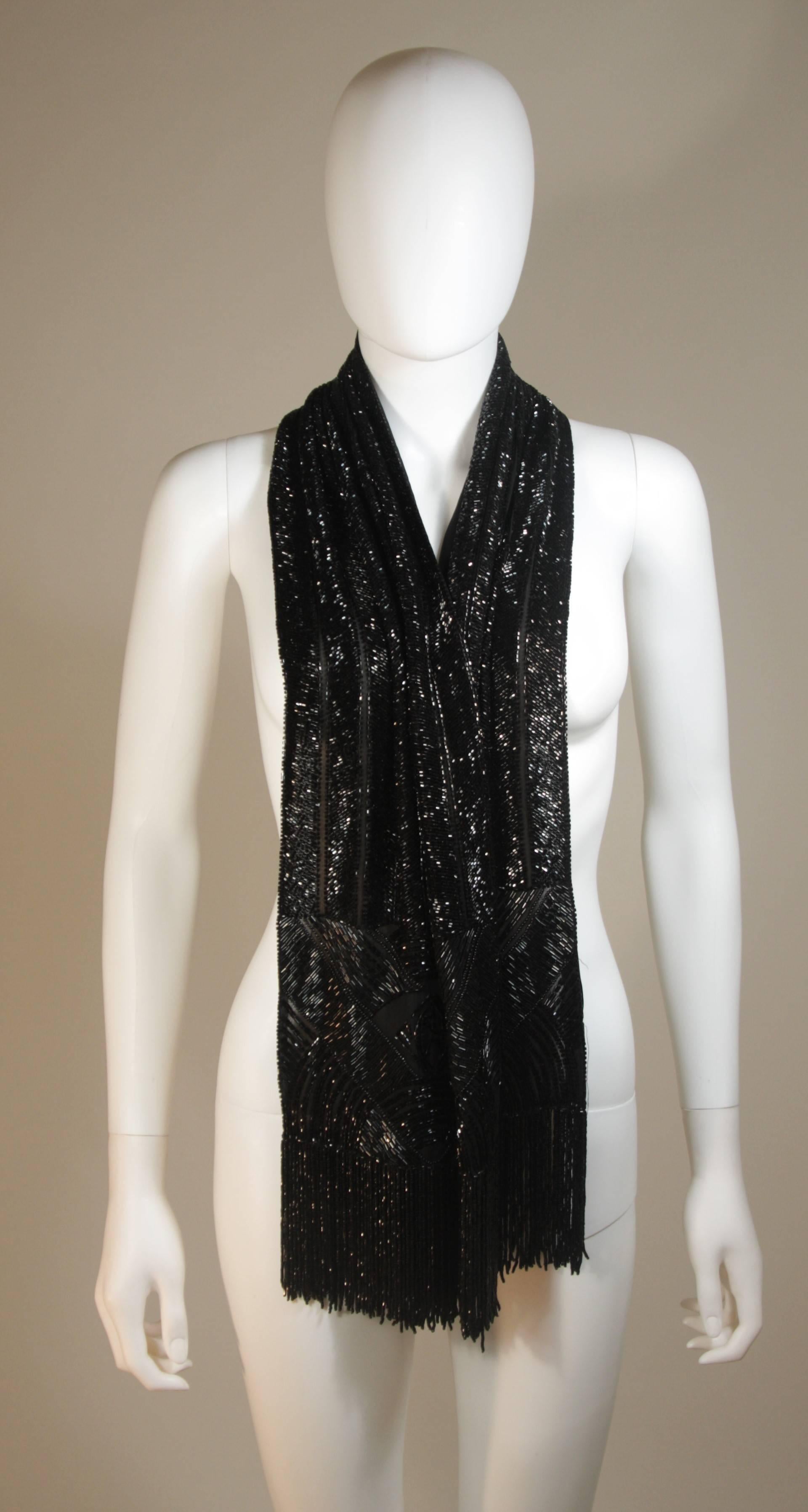 This Ralph Lauren scarf is composed of a beaded black silk with fringe. In excellent condition, comes with original box.

**Please cross-reference measurements for personal accuracy. 

Measurements (Approximately)  
Length: 62