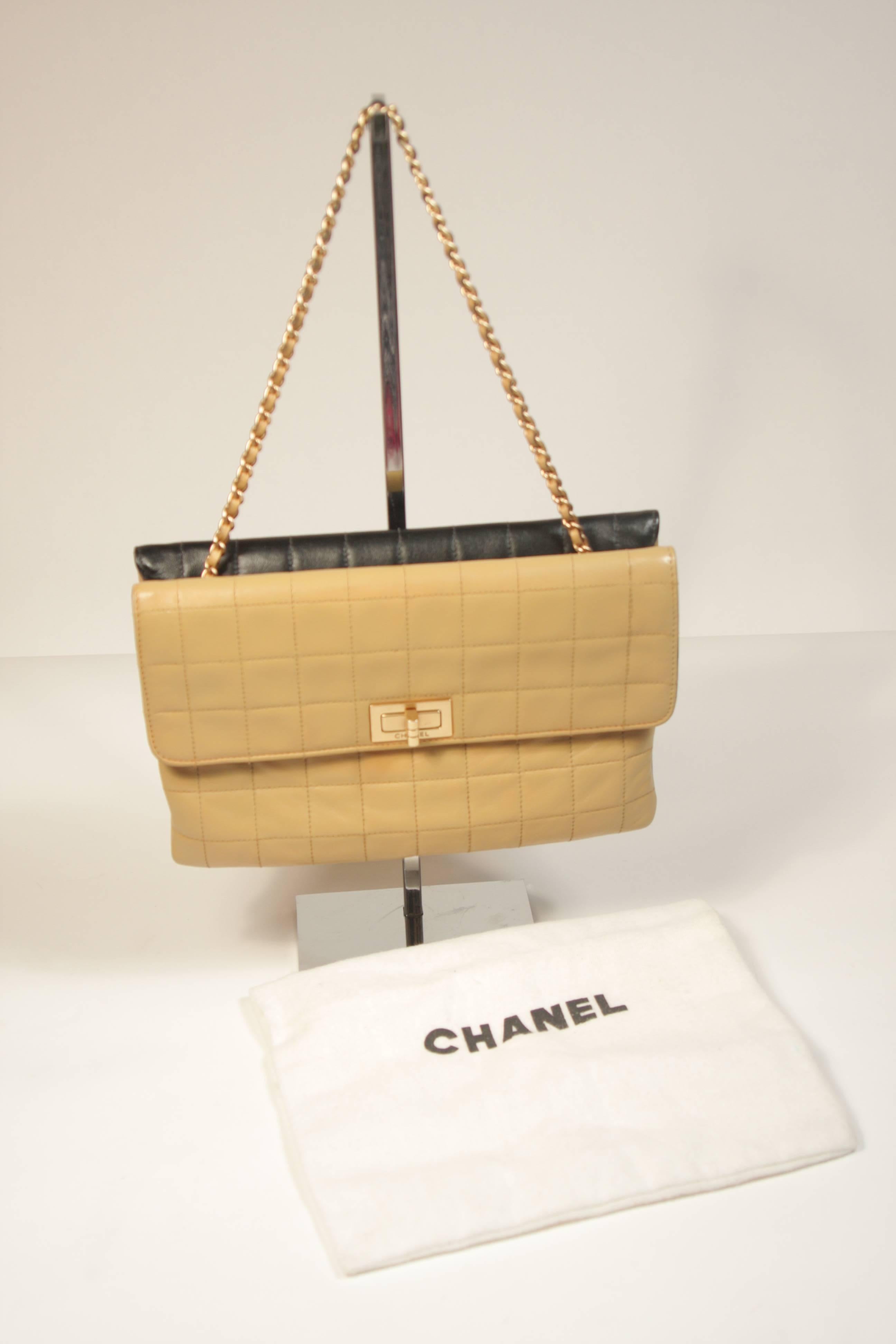 This Chanel handbag is composed of a cream and black lambskin leather with quilted design, this elegant flap features woven-in leather chain straps, exterior back pocket and gold-tone turn-lock closure. Comes with sleeper bag. In excellent