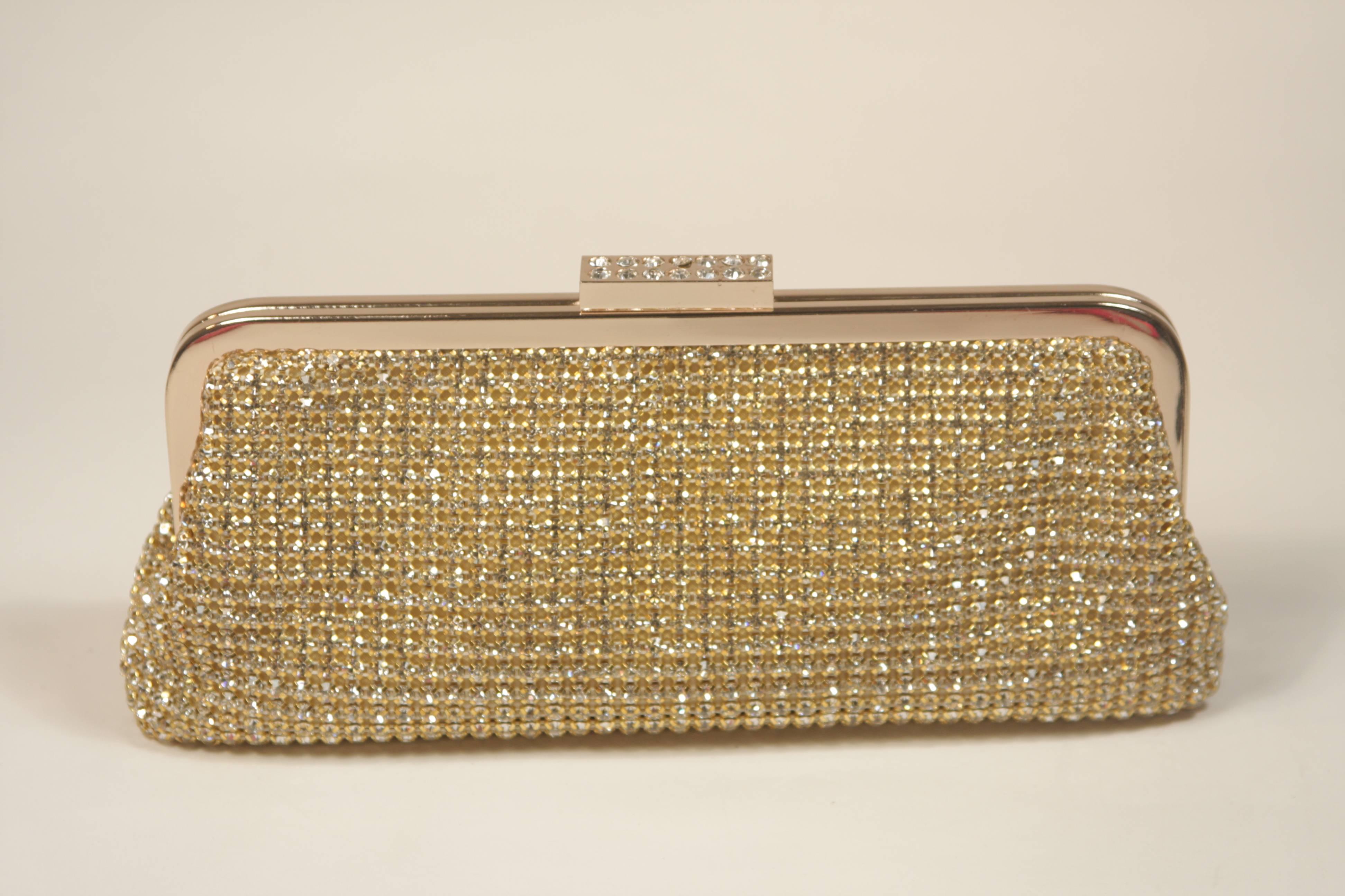  This Elizabeth Mason Couture clutch is composed of a gold and rhinestone encrusted combination, features a clasp closure. There is an optional strap. In new or unused condition.

  **Please cross-reference measurements for personal accuracy.