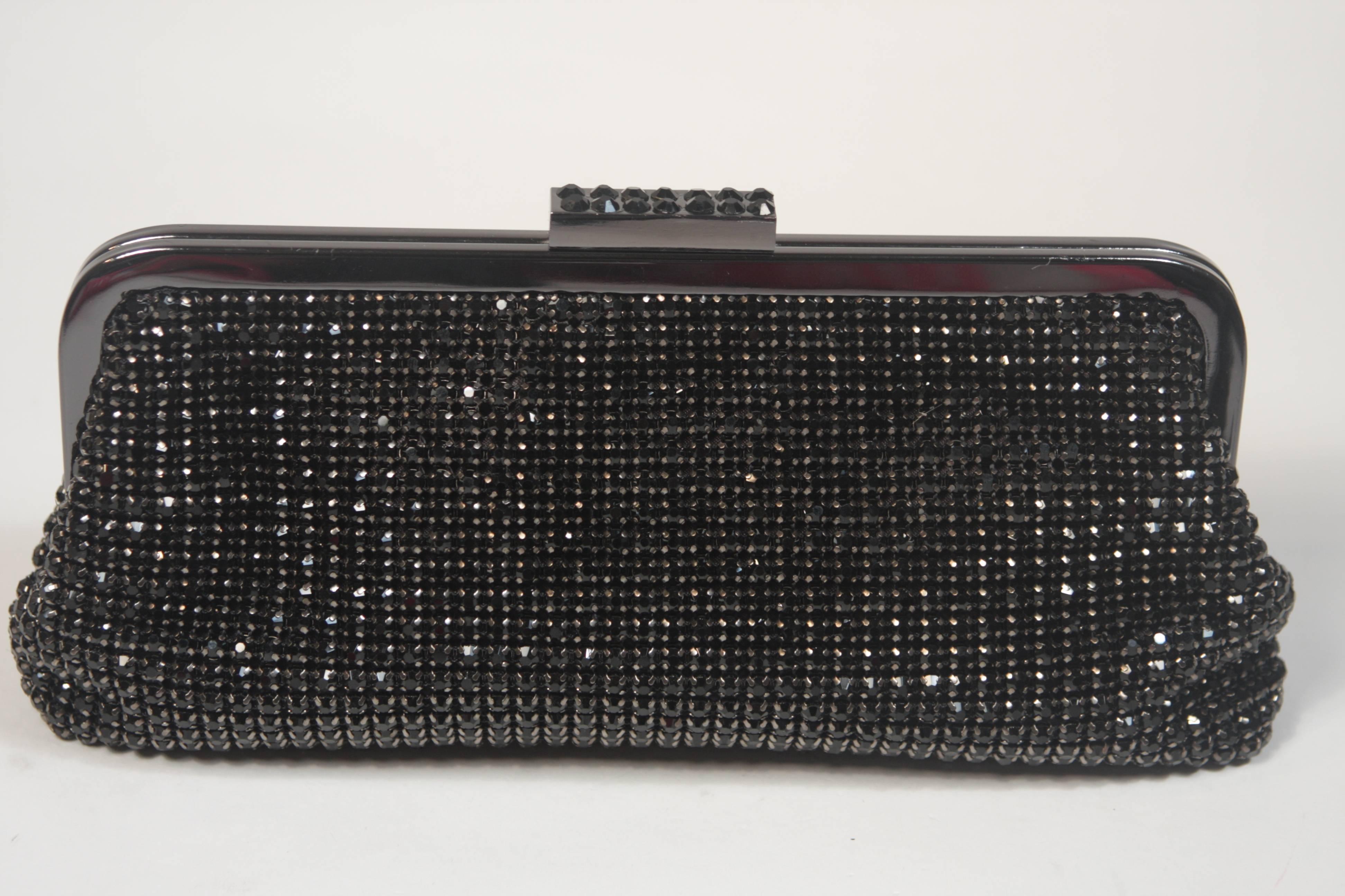  This Elizabeth Mason Couture clutch is composed of a black and gunmetal rhinestone encrusted combination, features a clasp closure. There is an optional strap. In new or unused condition.

  **Please cross-reference measurements for personal