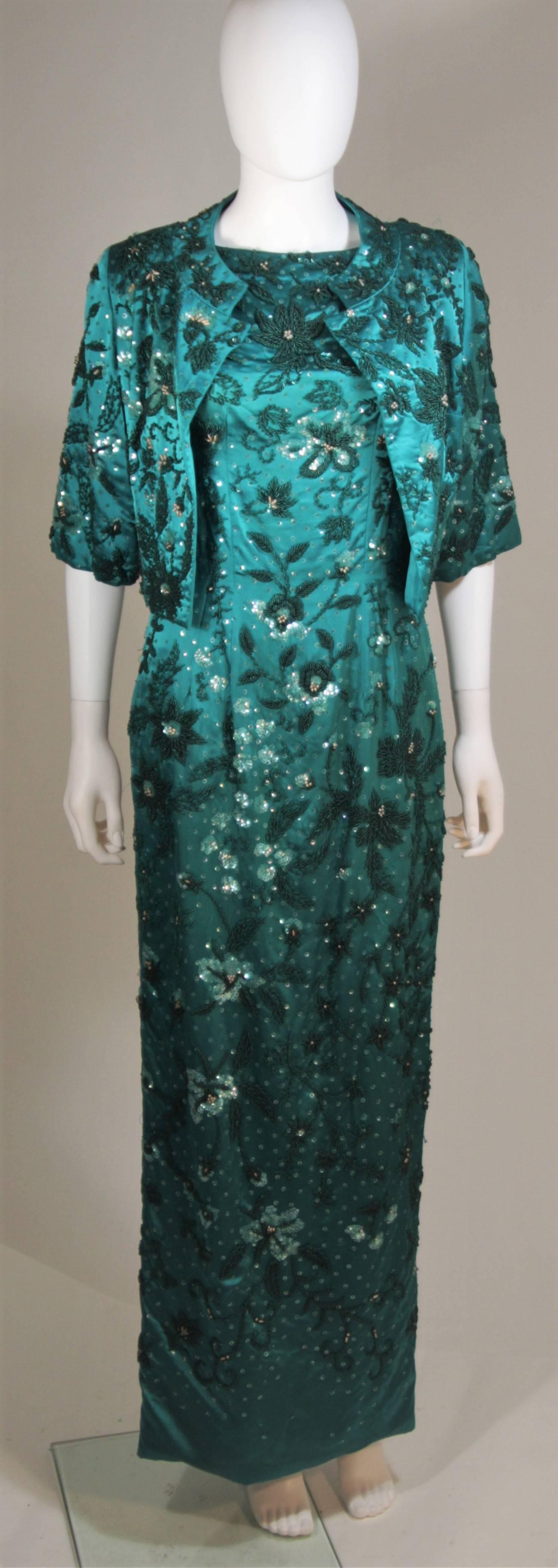 This custom 1960's ensemble is composed of a deep green embellished silk with a floral motif. The jacket features center front hook and eye closures and the gown has a center back zipper closure. In excellent vintage condition. 

  **Please