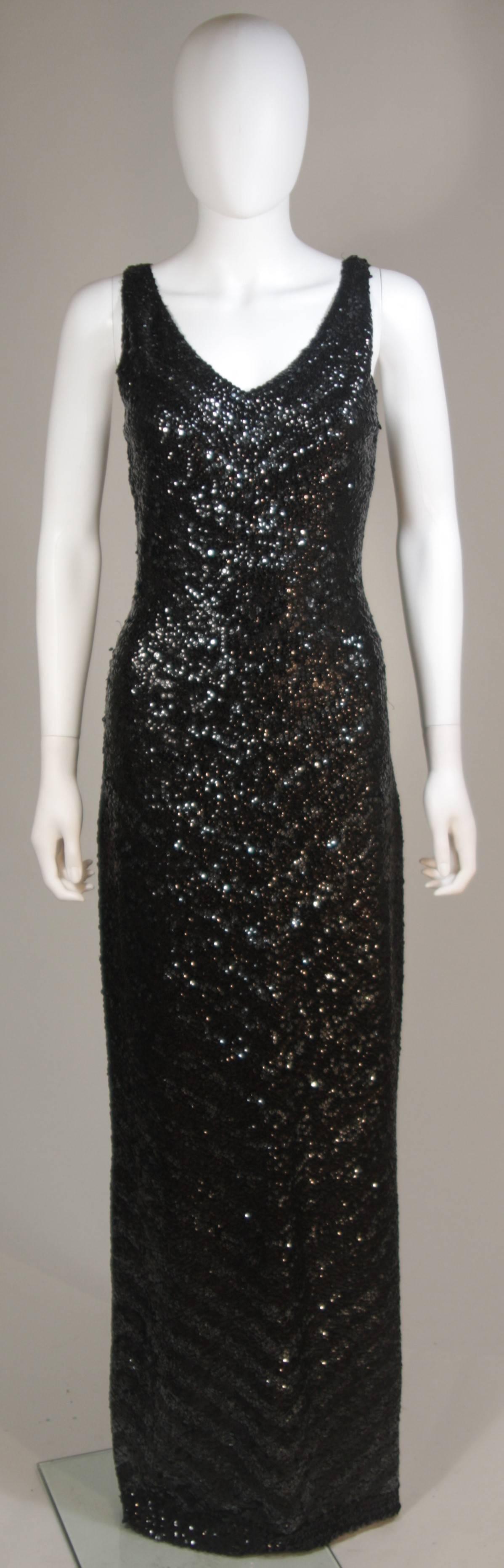  This Gene Shelly's International  gown is composed of a stellar stretch knit black wool with sequins. There is a center back zipper closure, v-neckline, and small side slit on the left side. Superb design. In excellent vintage condition. 

 