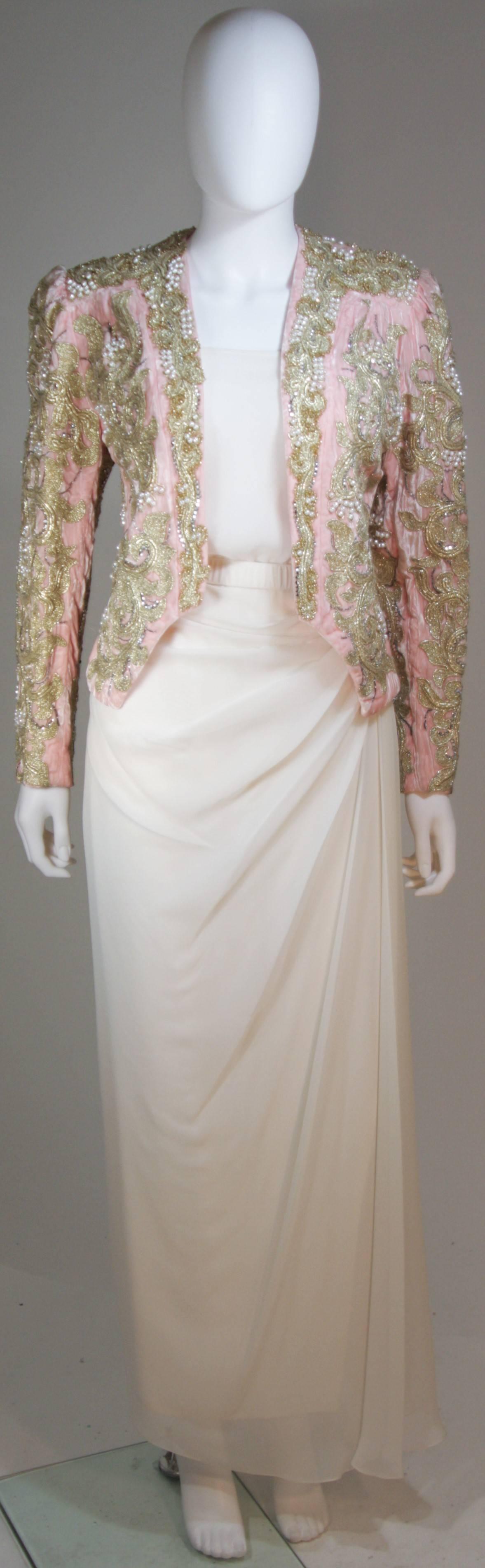  This Adolfo evening ensemble is composed of a pink embroidered velvet jacket with a ivory hued silk blouse and skirt. The jacket has an open front design, the blouse is pullover style, and the skirt has a zipper closure. In excellent great vintage