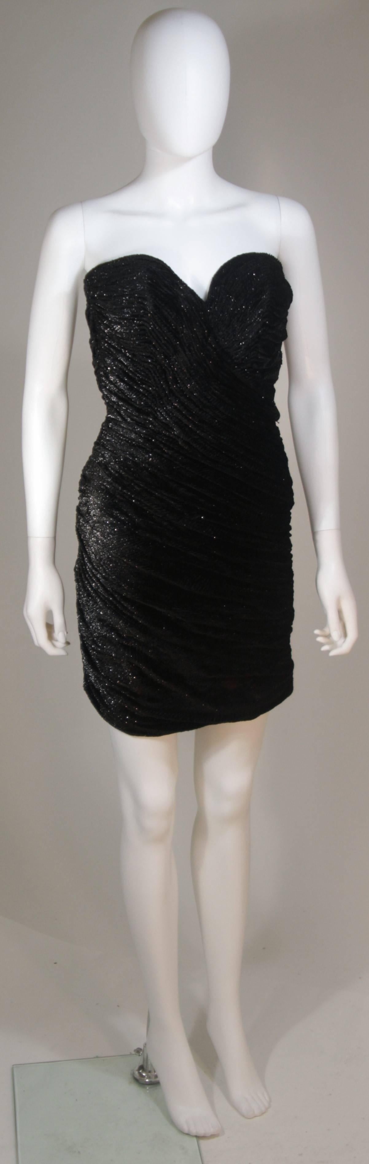  This Vicky Tiel cocktail dress is composed of a black on black lurex blended velvet. The dress features a sweetheart neckline, boned bodice, and allover ruched design. There is a center back zipper. In excellent vintage condition. 

**Please