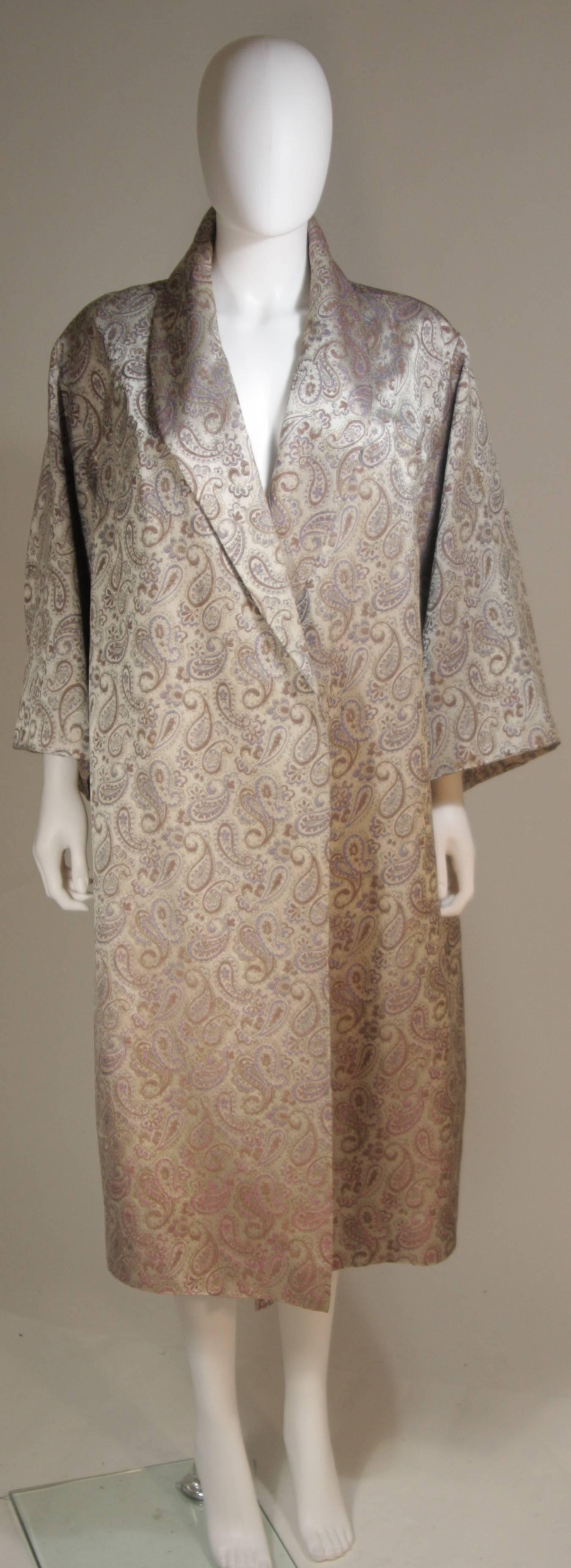  This Vintage coat is composed of a silk paisley print fabric in silver, mauve, and periwinkle. The coat has an open style design. In excellent vintage.

  **Please cross-reference measurements for personal accuracy. Size in description box is an