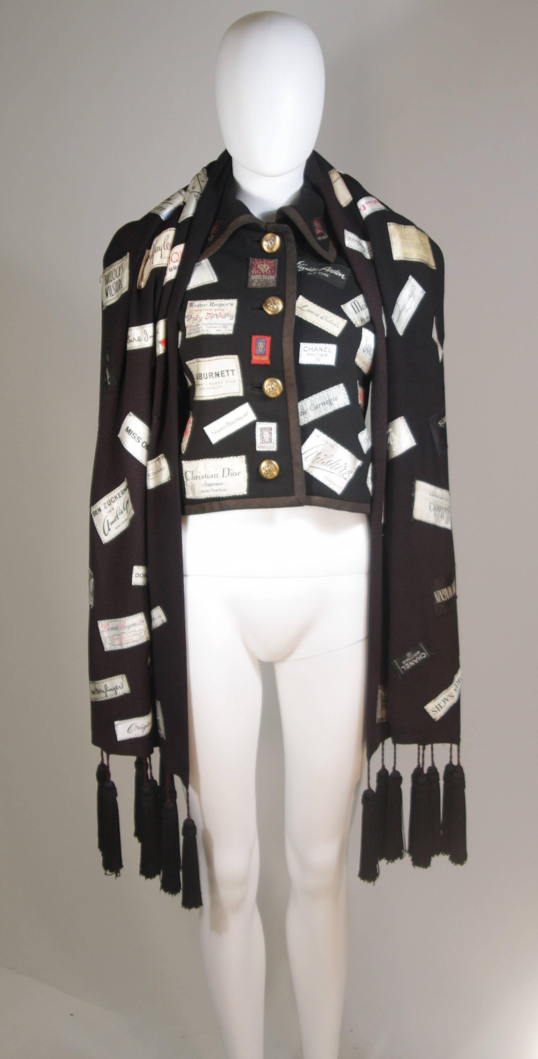 This Elizabeth Mason Couture wool crepe wrap is appliqued with vintage designer labels and features tassels. It is made in Beverly Hills. 

This is a couture custom order. Please allow for a 60 day lead time from measurements, fabric selection,