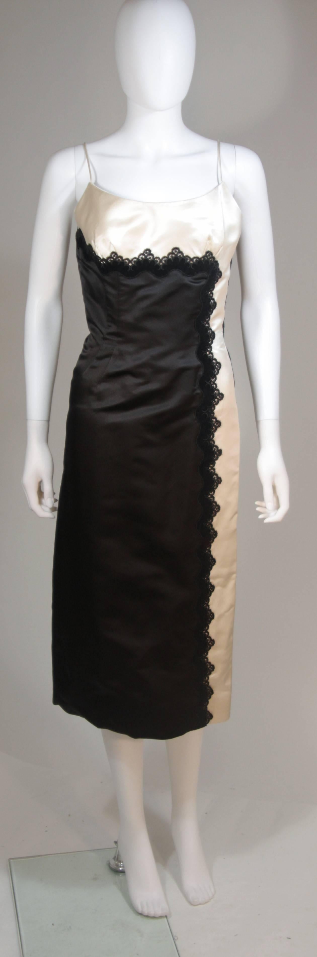  This Oleg Cassini  cocktail dress is composed of black and off-white silk with lace applique. There is a center back zipper closure. and spaghetti strap. In excellent vintage condition. 

  **Please cross-reference measurements for personal