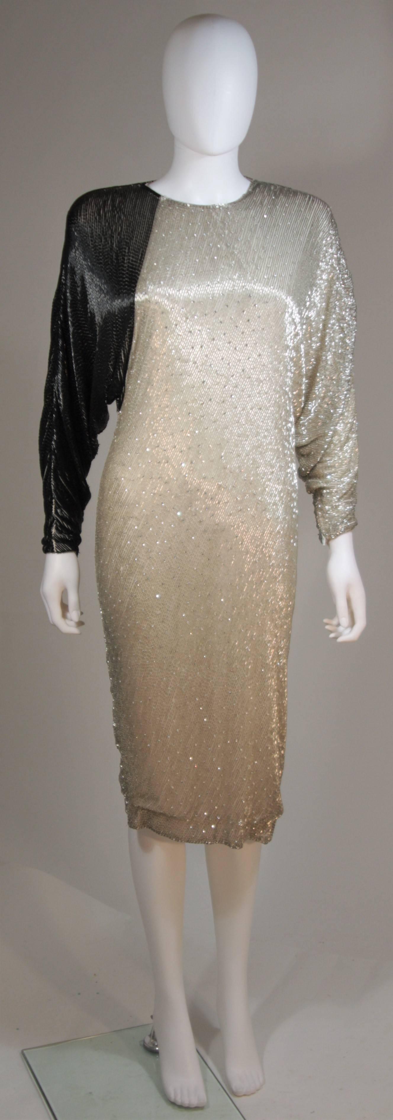  This vintage cocktail dress is composed of a beaded silk with a silver and black combination. This dress features batwing sleeve and a center back zipper closure. In great vintage condition, a few missing beads. 

  **Please cross-reference