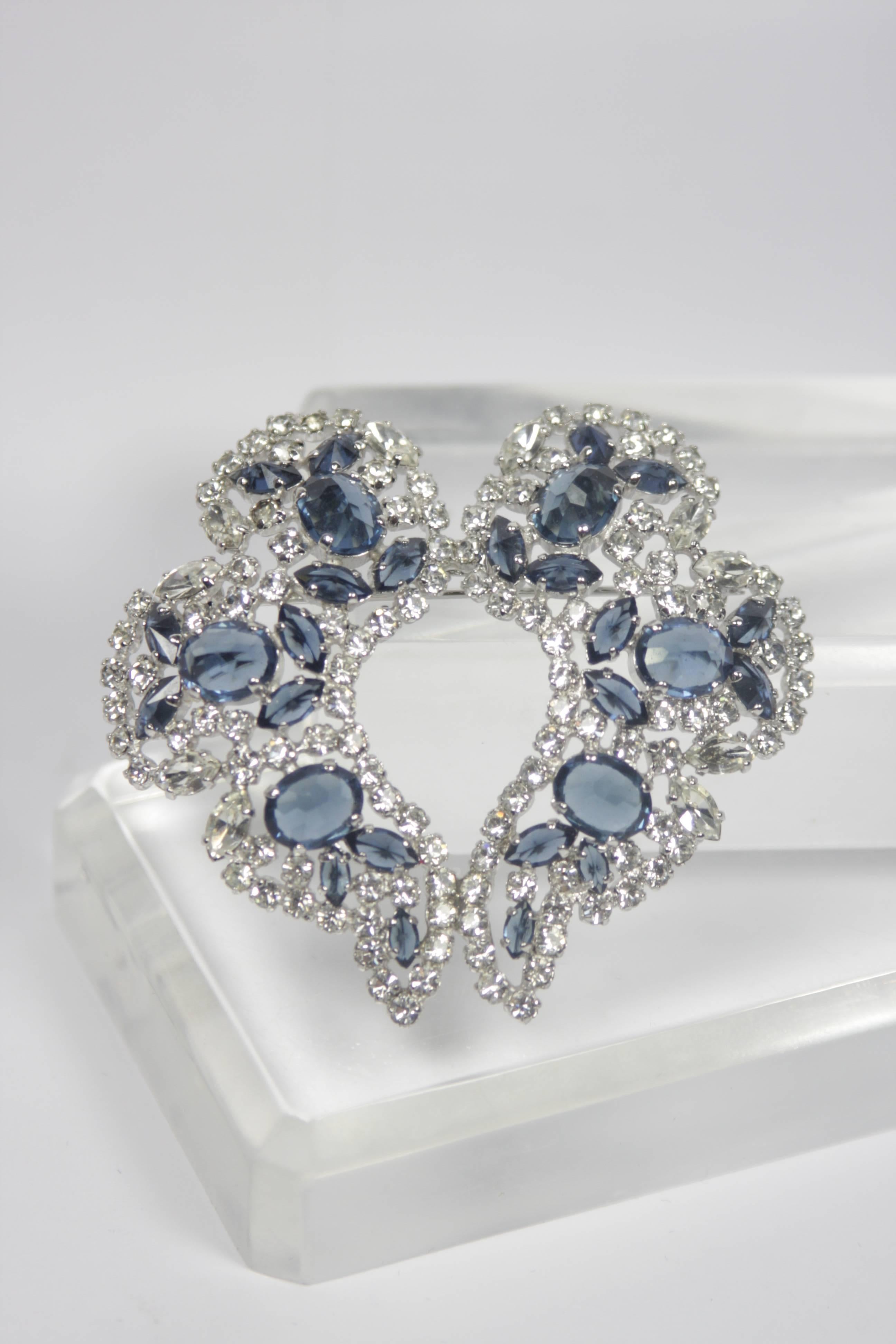 This Sherman brooch features a white and blue sapphire hue rhinestones, set in a white gold hue metal. A lovely piece in excellent vintage condition. 

  **Please cross-reference measurements for personal accuracy. 

Measures