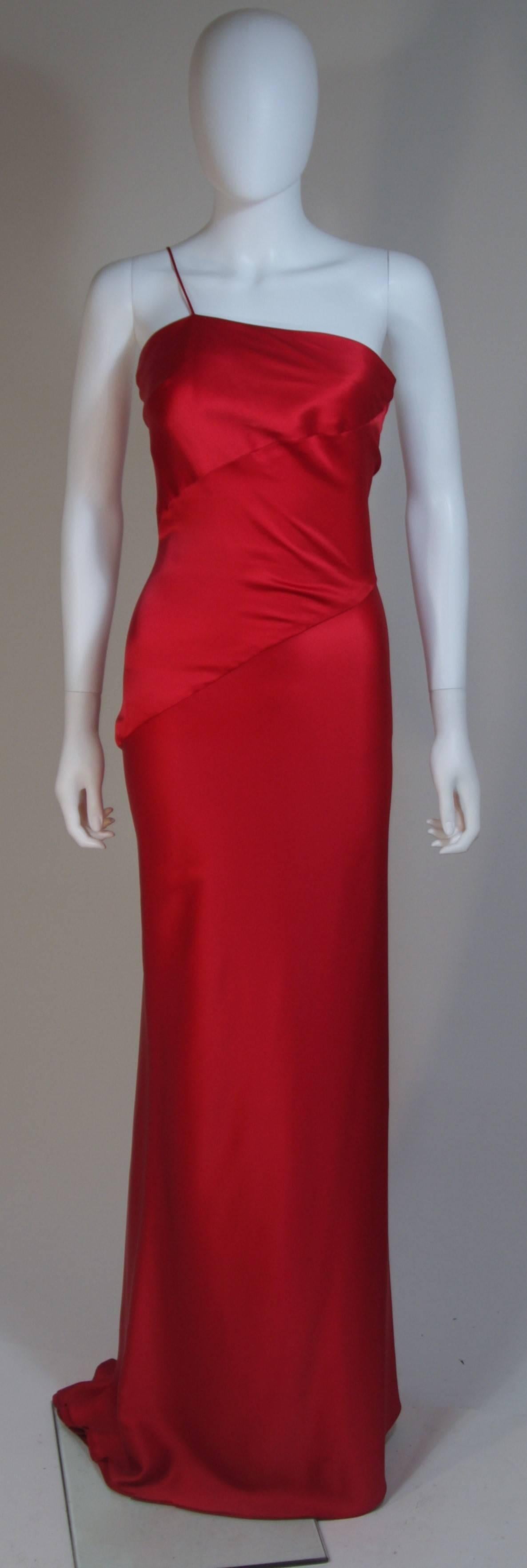  This Cantu & Castillo gown is composed of a red bias cut silk. Features an asymmetrical one shoulder strap design. In excellent condition. 

  **Please cross-reference measurements for personal accuracy. Size in description box is an