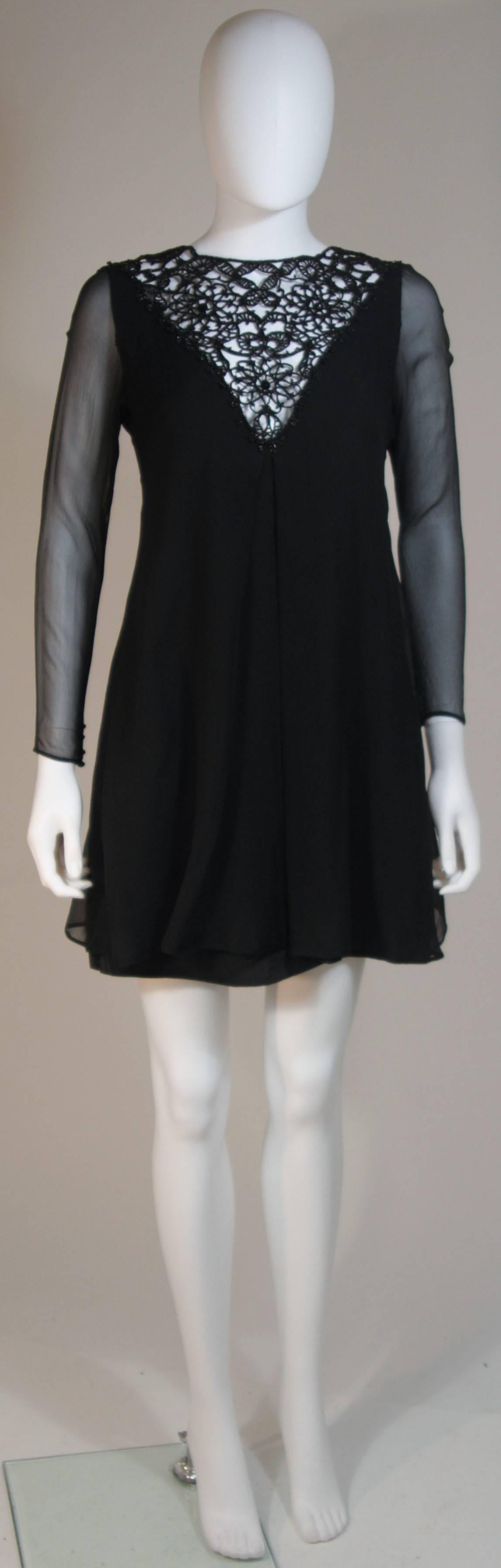  This custom 1960's  cocktail dress is composed of a black silk chiffon and features an embellished neckline. There is a center back zipper closure. In excellent vintage condition. 

  **Please cross-reference measurements for personal accuracy.