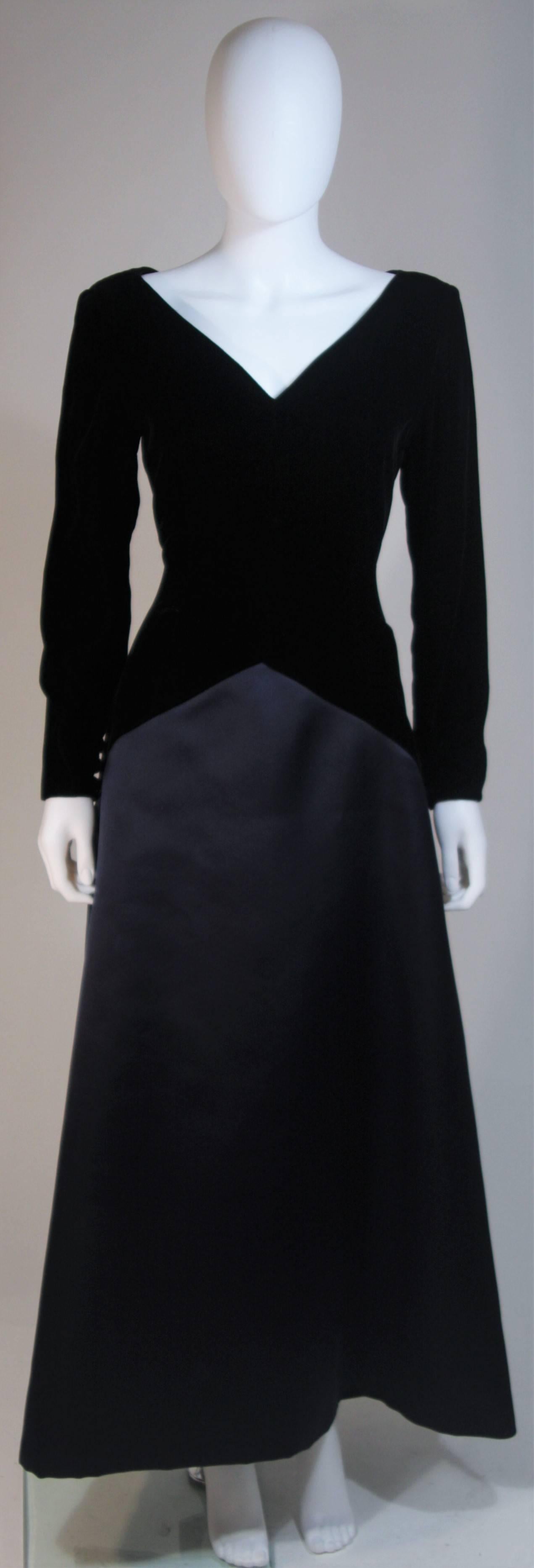  This Bill Blass  gown is composed of a black velvet with contrasting satin skirt. There is a center back zipper closure and button closures at the sleeve end. In excellent vintage condition. 

  **Please cross-reference measurements for personal