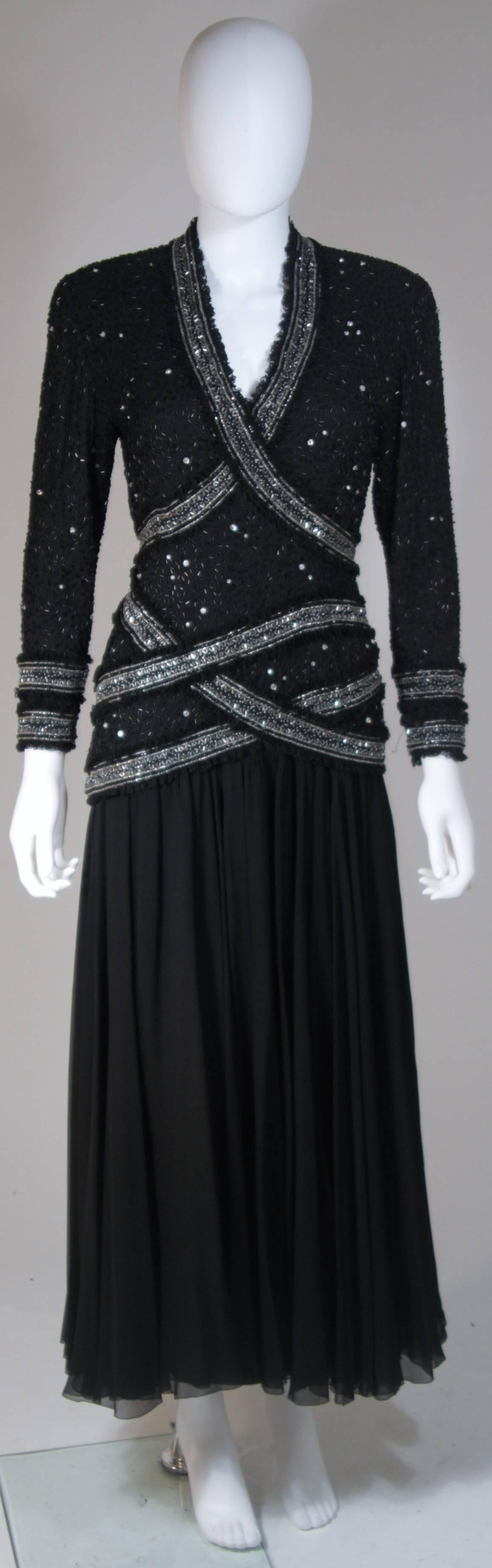  This Fabrice New York Couture gown is composed of a black silk chiffon and features an embellished bodice trimmed with lace. There is a center back zipper closure and zippers at the sleeve end. In excellent vintage condition. 

  **Please