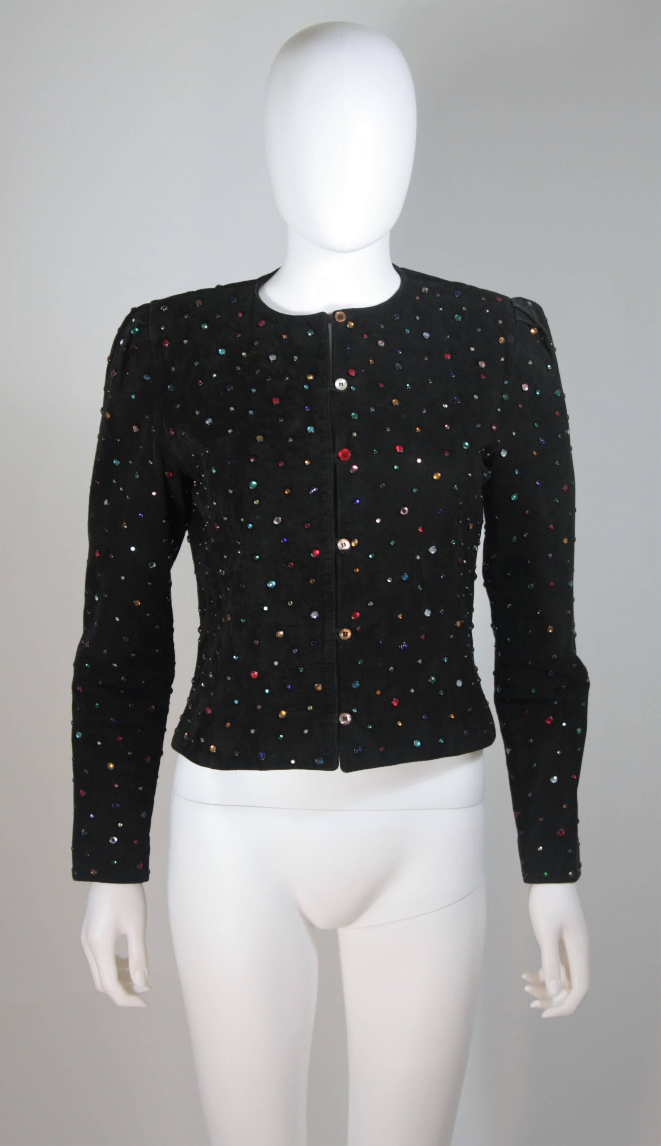  This jacket is composed of a black suede and features multi-color rhinestone applique. There are center front button closures. The shoulders features a gathered detail. In great vintage condition. 

  **Please cross-reference measurements for