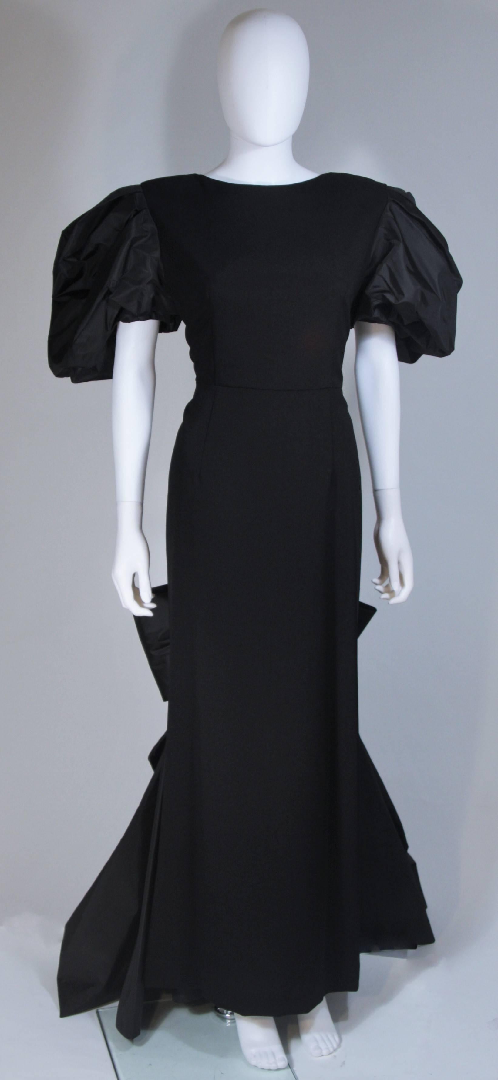  This Victor Costa gown is composed of a wool and silk taffeta contrast. Features large puff sleeves and bow at the center back skirt. There is a center back zipper and train. In excellent condition. 

**Please cross-reference measurements for