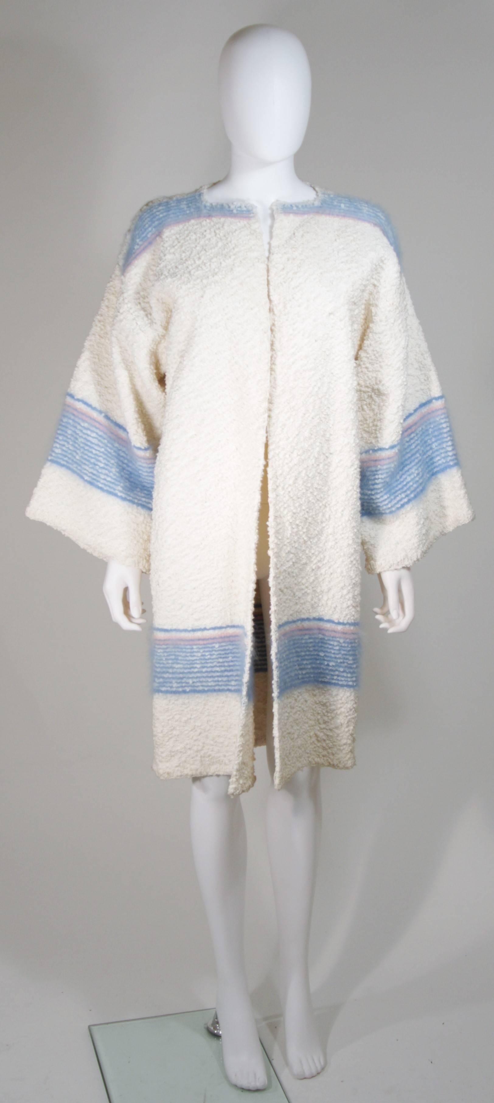   This Michaele Vollbracht coat is composed of a wool boucle with Angora accents. Features a classic open style design. In excellent vintage condition. 

  **Please cross-reference measurements for personal accuracy. 