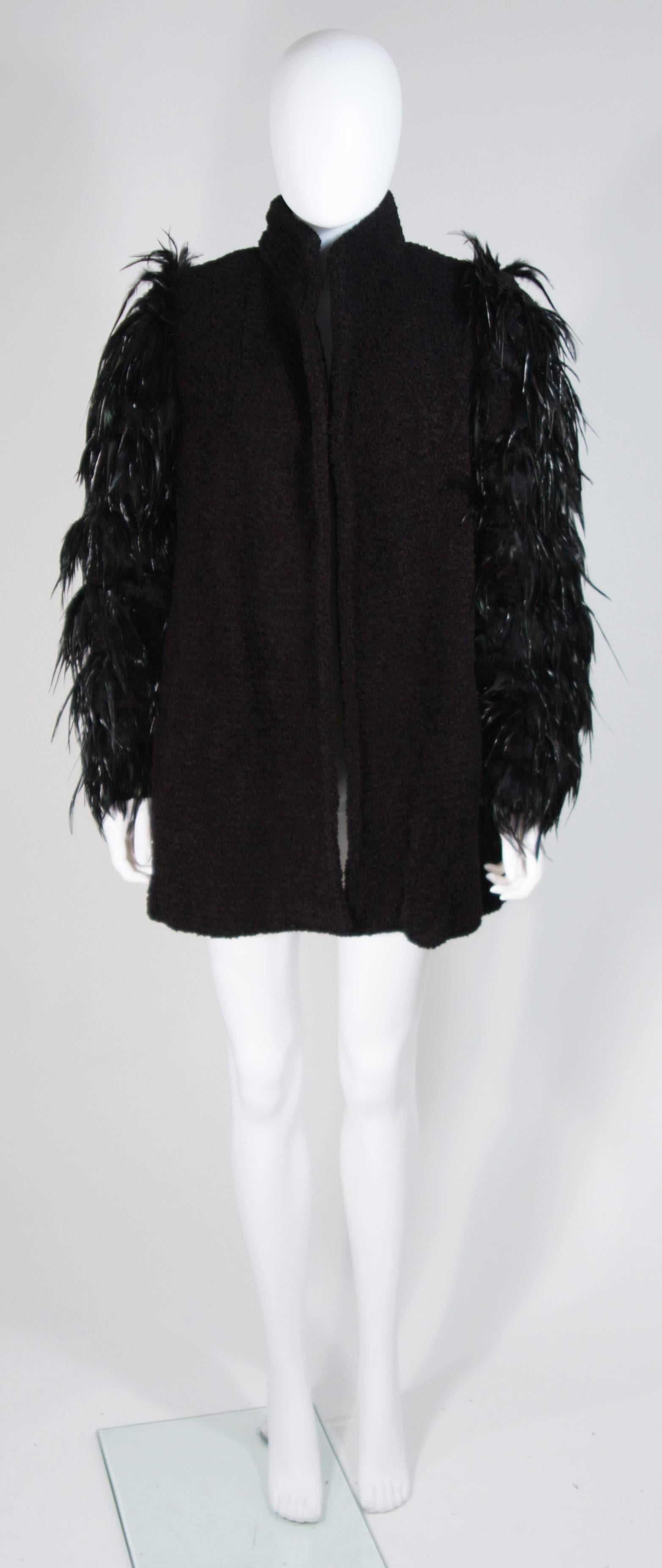   This Ted Lapidus  jacket is composed of a black lana wool and features black feather applique on the sleeves. Open style design, side pockets, and a mandarin style collar. In excellent vintage condition. 

  **Please cross-reference measurements