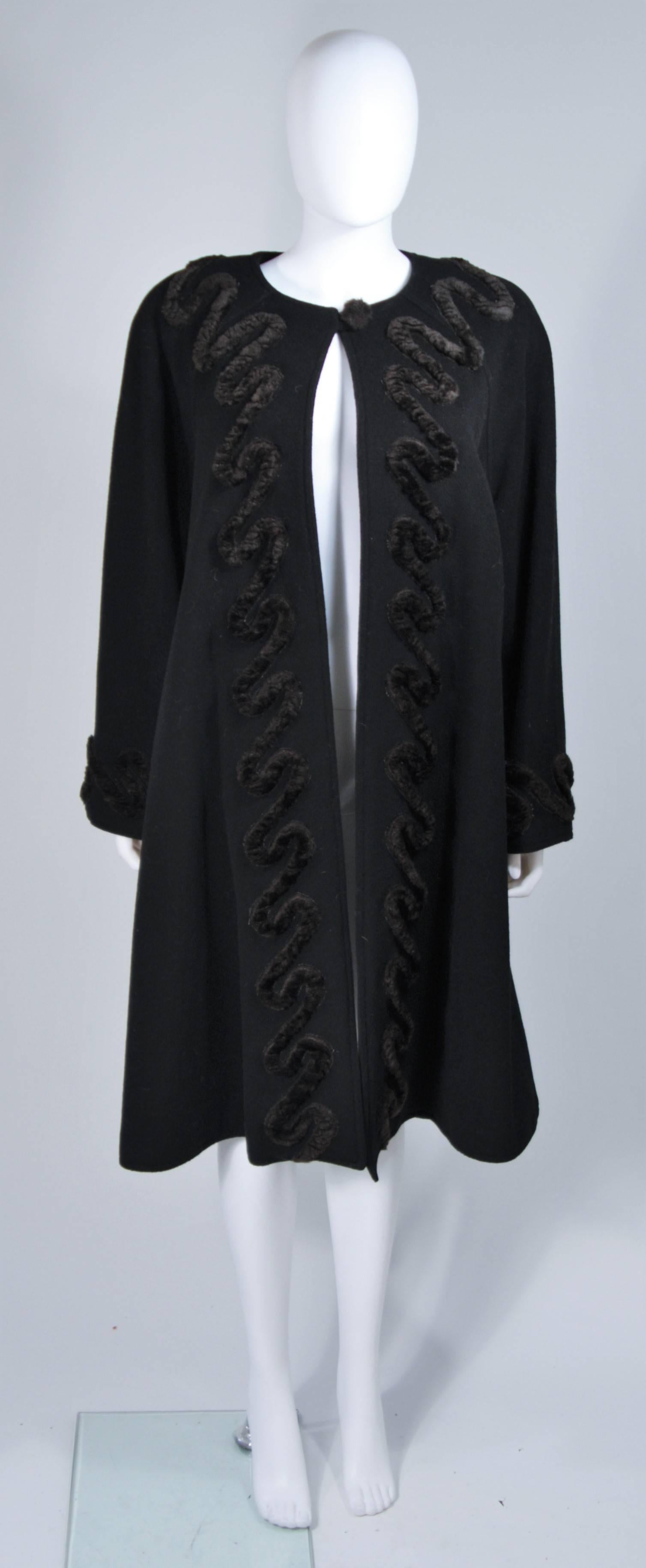 This Fendi coat is composed of a black lana wool and features a faux fur applique in a swirl pattern. There is a hook and eye closure with side pockets. In excellent vintage condition. 

**Please cross-reference measurements for personal accuracy.