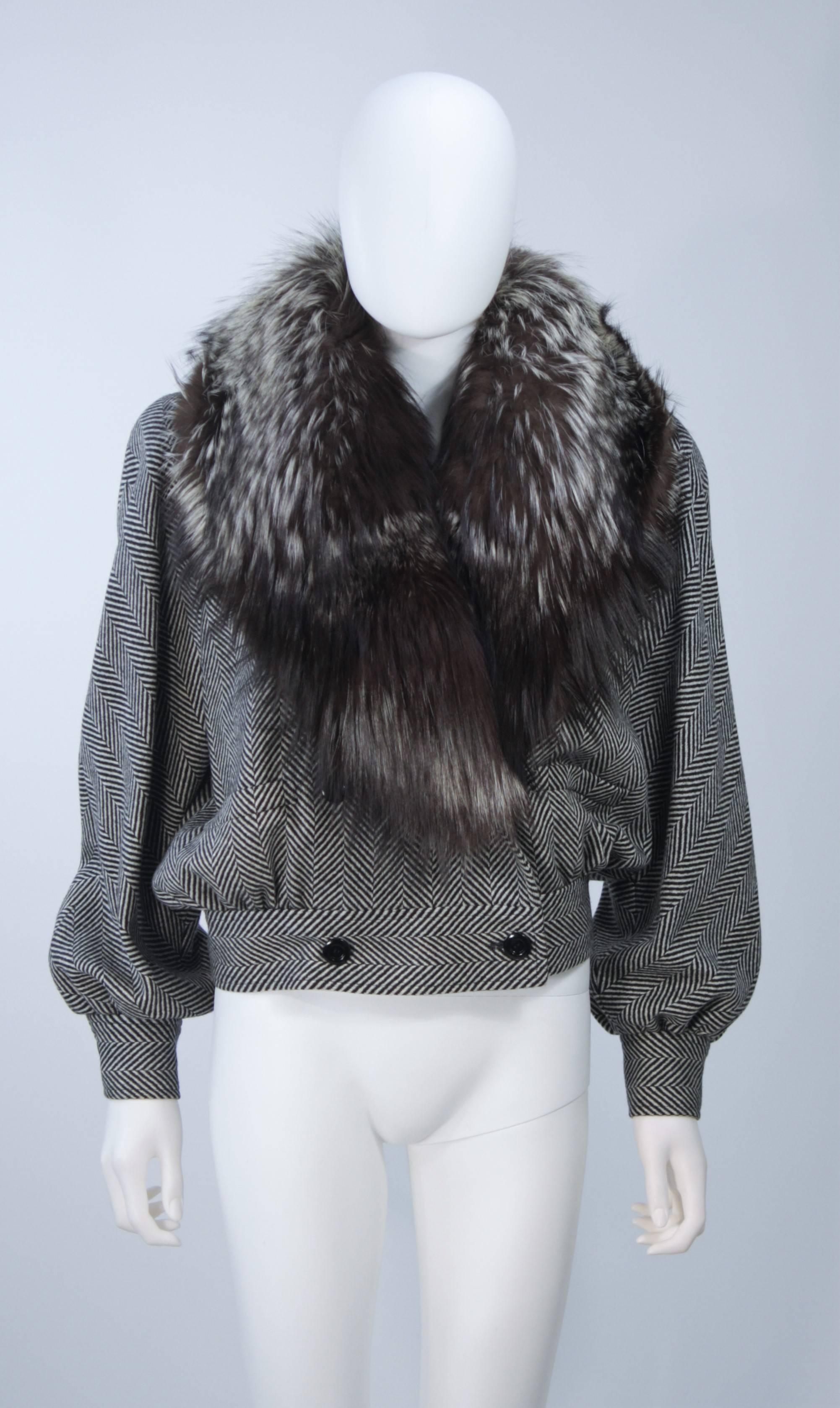  This Valentino jacket is composed of a black and white wool bomber style jacket with a brown and cream fox collar. The jacket has front button closures with a double breasted style, and front pockets. There are shoulder pads.  In excellent vintage