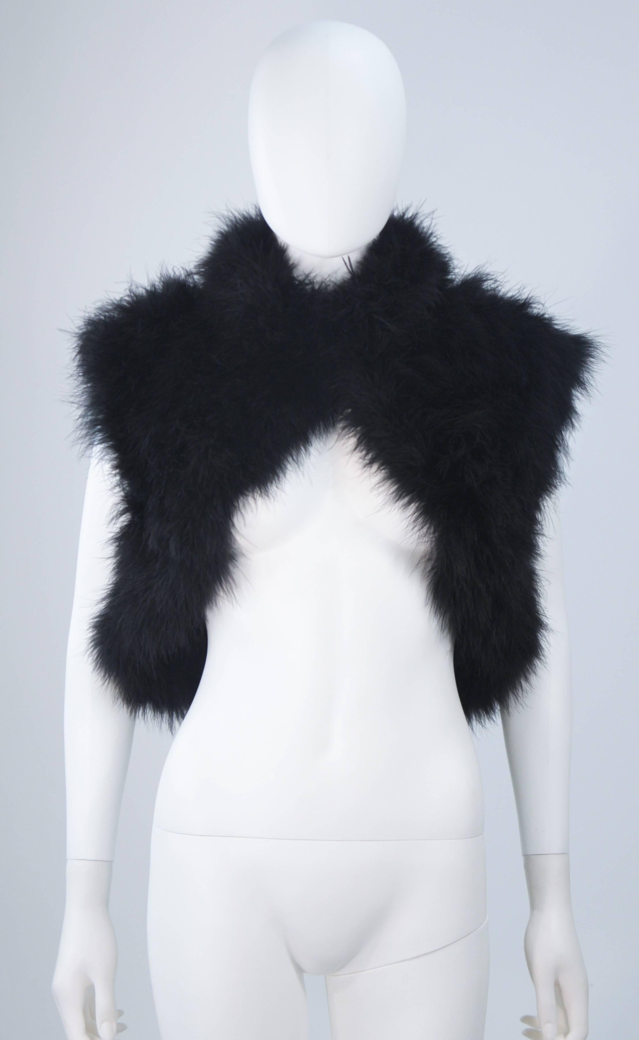 This Elizabeth Mason Couture Marabou garment is composed of a superiorly supple marabou in a stunning black hue. Features a hook and eye closure. Designed in Beverly Hills.

This is a couture custom order. Please allow for a 60 day lead time from