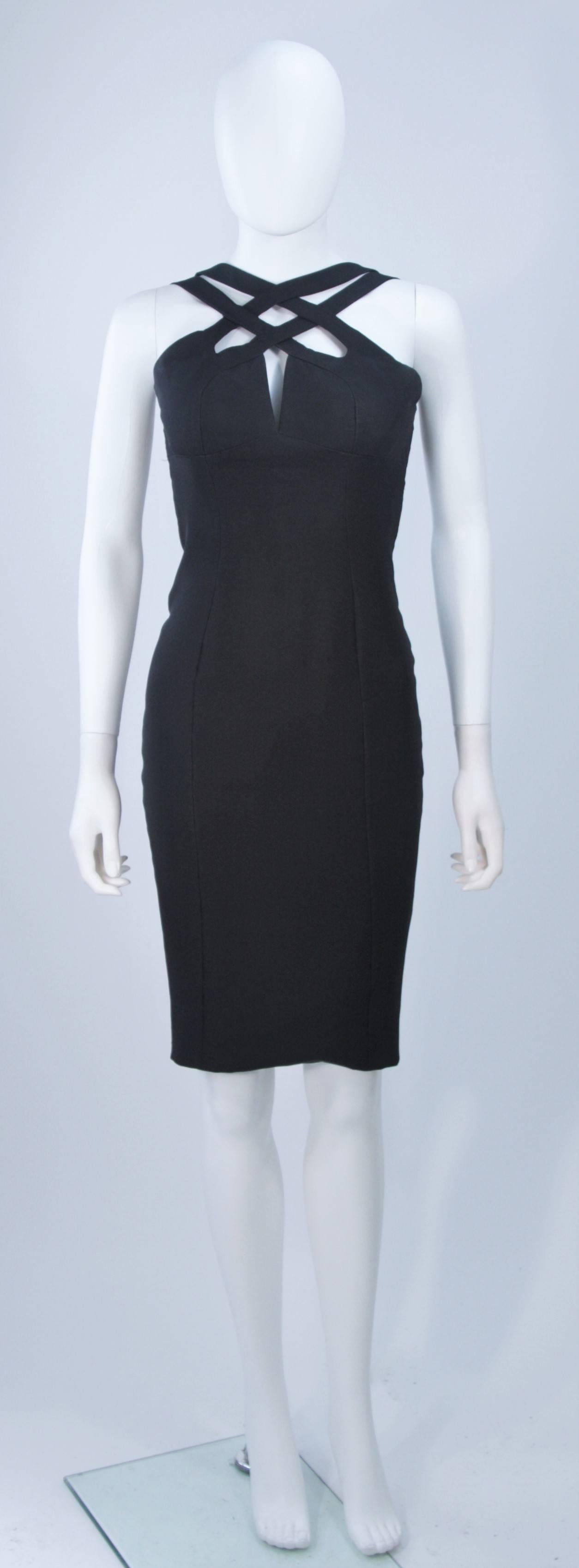 This Elizabeth Mason Couture cocktail dress is fashioned from the finest black silk dupioni and features gorgeous body skimming silhouette with a stunning peek-a-boo criss-cross detail. It is such a fabulous and chic design. Made in Beverly