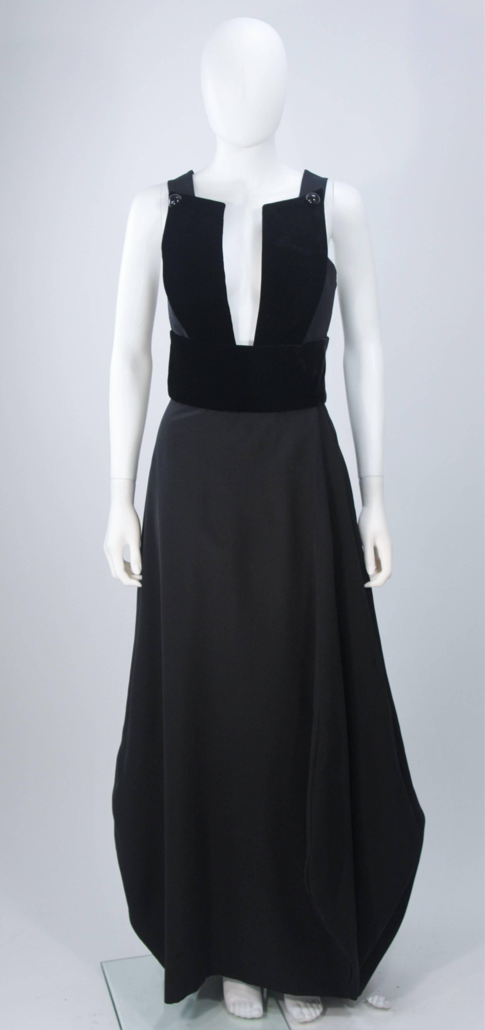  This Giorgio Armani design is available for viewing at our Beverly Hills Boutique. We offer a large selection of evening gowns and luxury garments. 

 This gown is composed of a black silk and velvet combination. Features a structured plunging