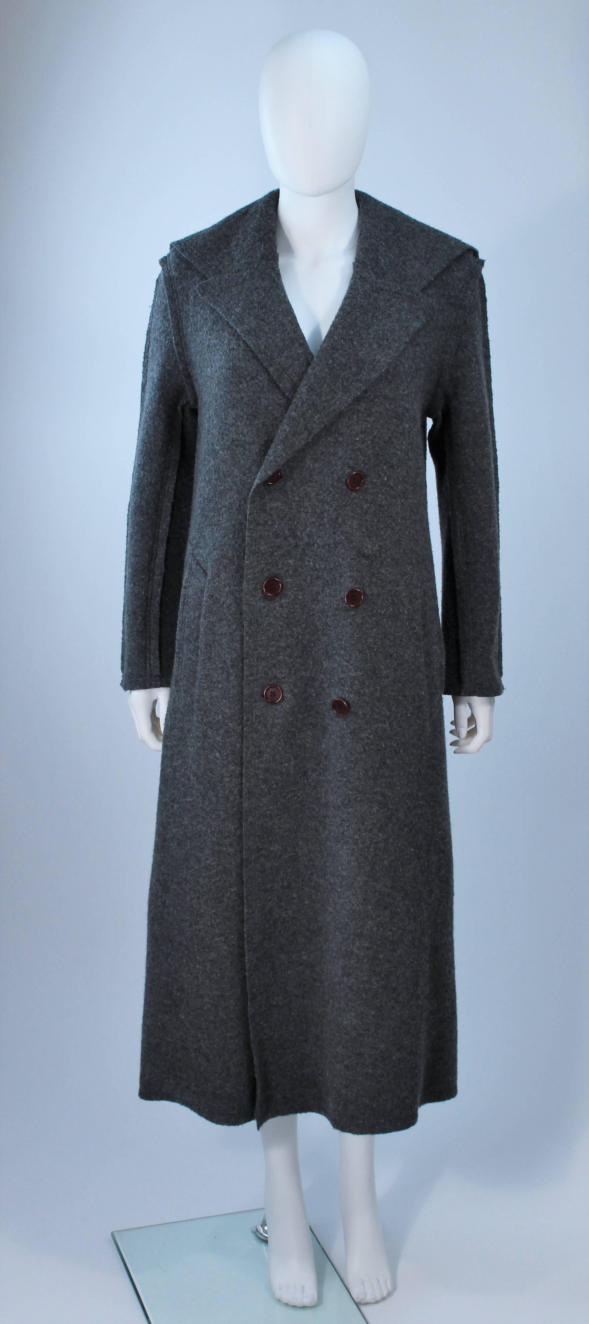  This Commes Des Garcon coat is composed of grey boiled wool. Features top stitching and center front button closures with side pockets. In excellent vintage condition. 

**Please cross-reference measurements for personal accuracy. 

Measures