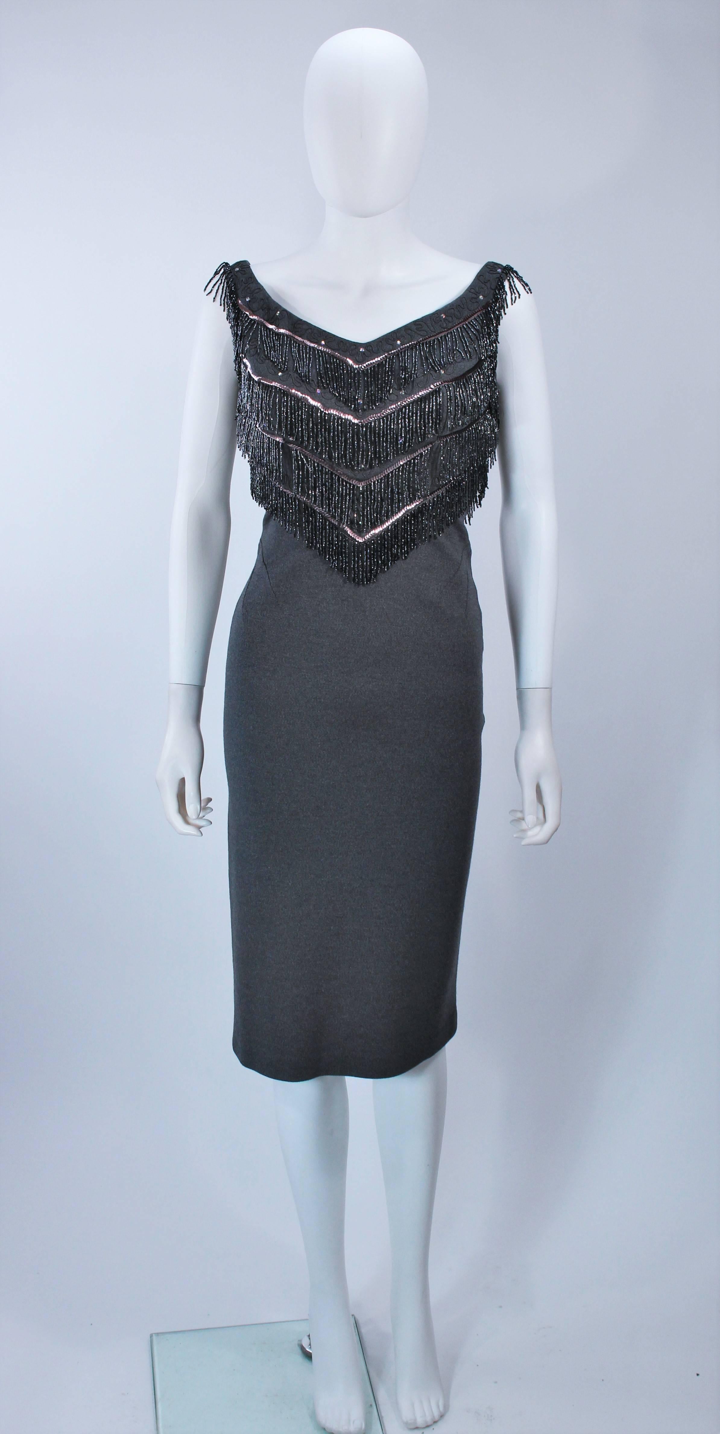  This Sydney North cocktail dress is composed of a stretch grey knit wool with metallic beaded trim. There is a center back zipper closure. In excellent vintage condition. 

**Please cross-reference measurements for personal accuracy. Size in