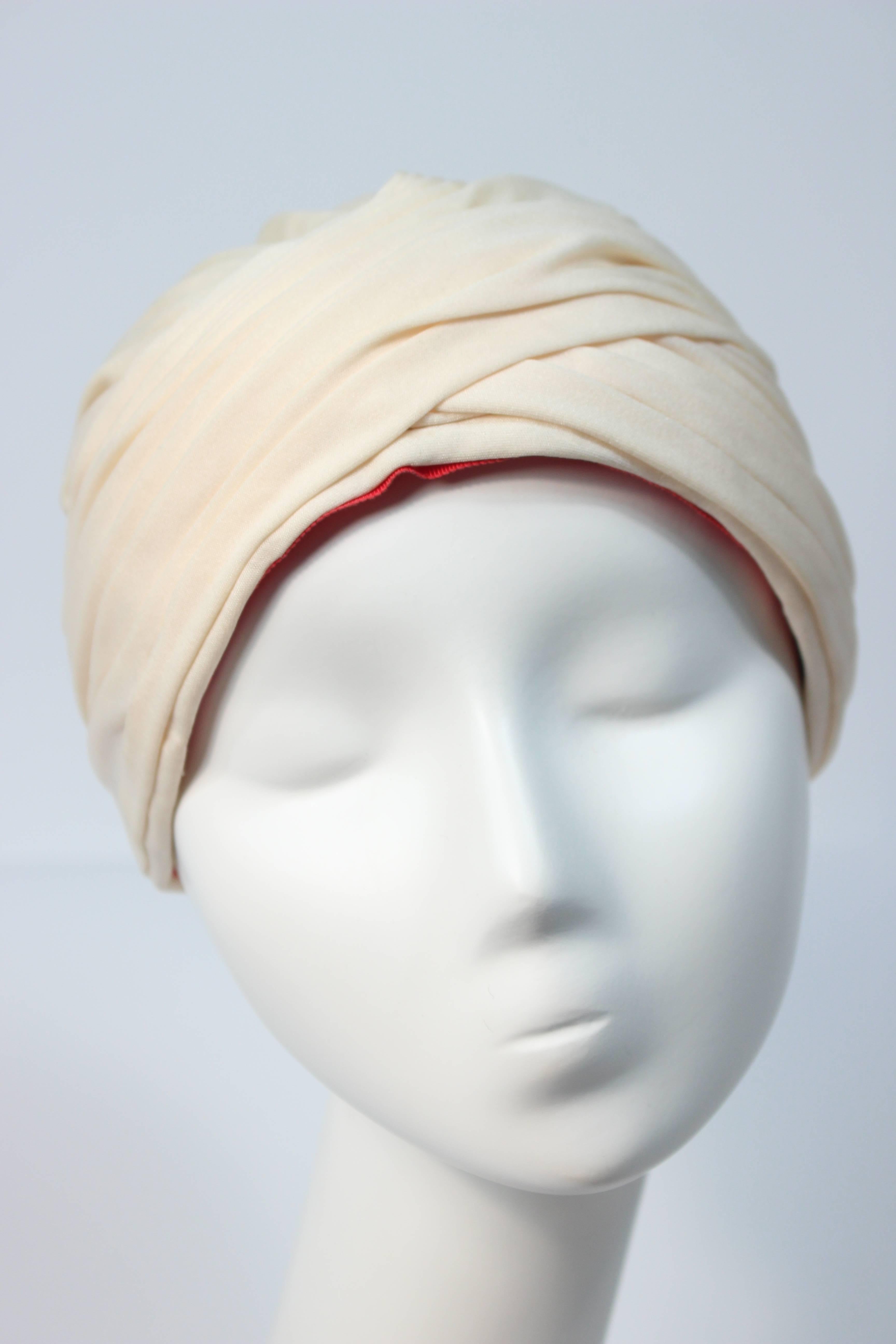  This Adolfo  turban is composed of a cream hue jersey. In great vintage condition, some slight color variation due to age, minimal. 

  **Please cross-reference measurements for personal accuracy. 

Measures (Approximately)
Depth: 5