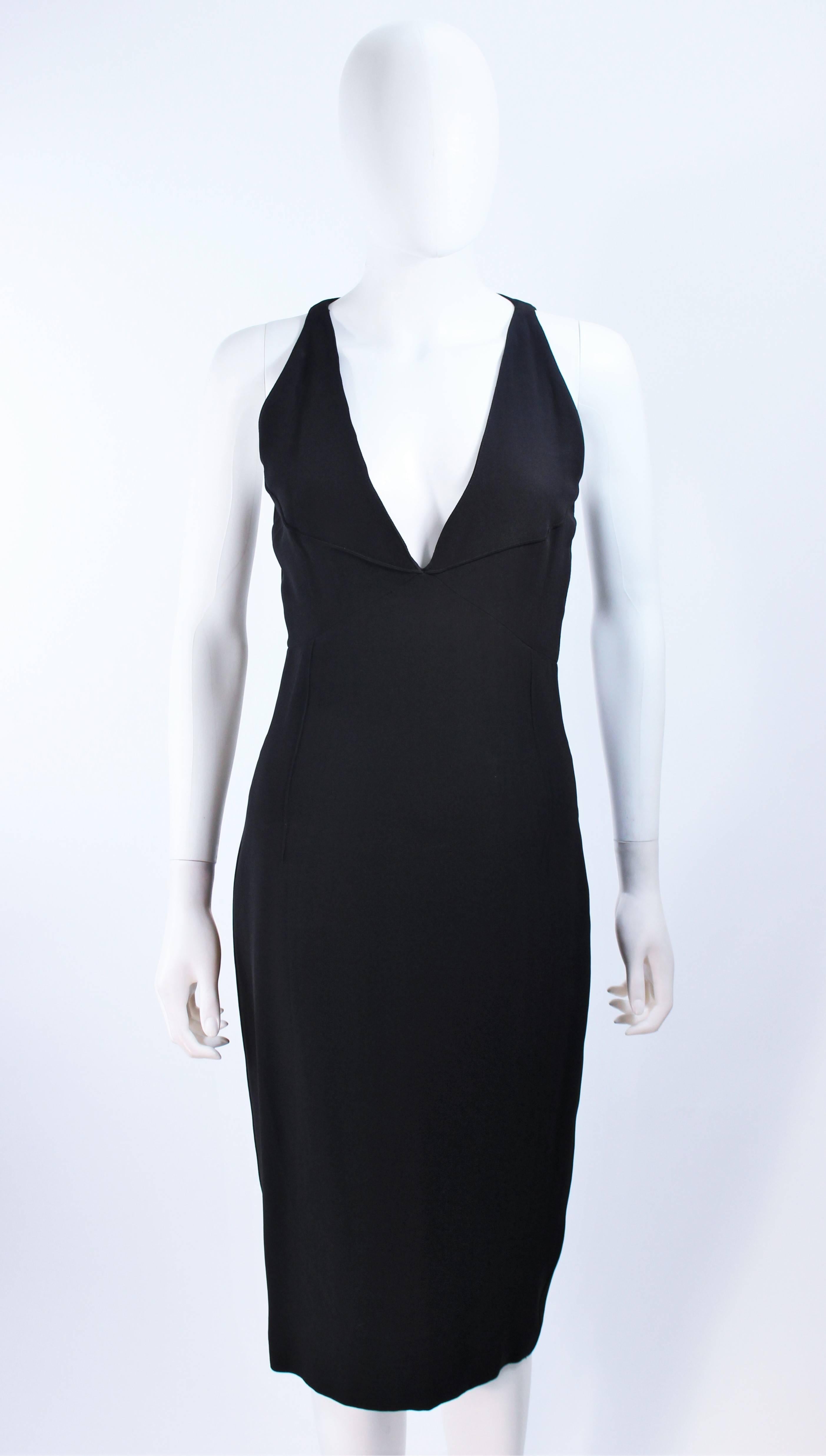 This Fendi cocktail dress is composed of a black viscose/rayon/acetate blend. Features external pipping details, a plunge neckline, and center back zipper closure. In excellent vintage condition.

**Please cross-reference measurements for personal