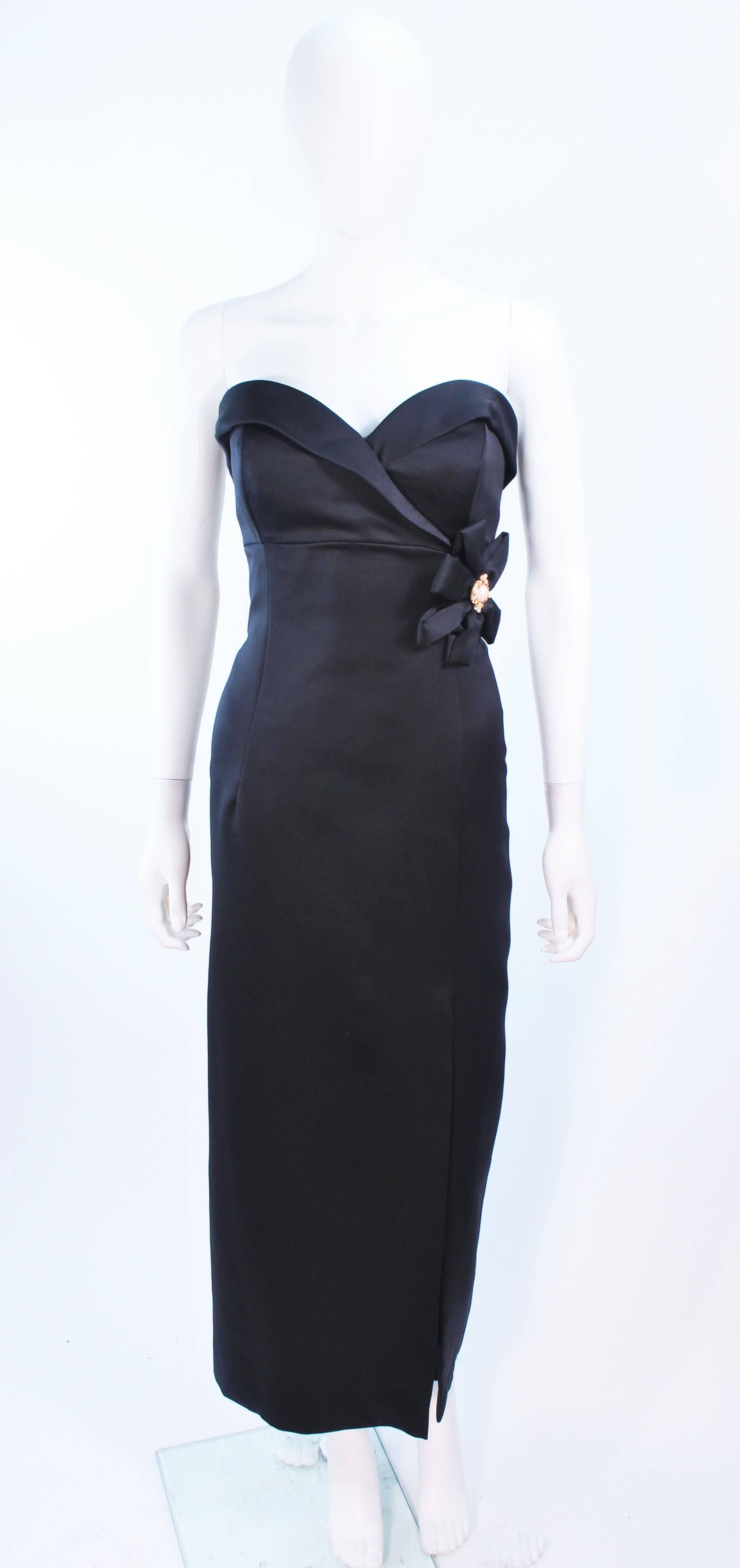 This Victor Costa gown is composed of black satin and features a side bow. There is a draped style boned bustier with front slit. There is a center back zipper closure. In excellent vintage condition.

**Please cross-reference measurements for