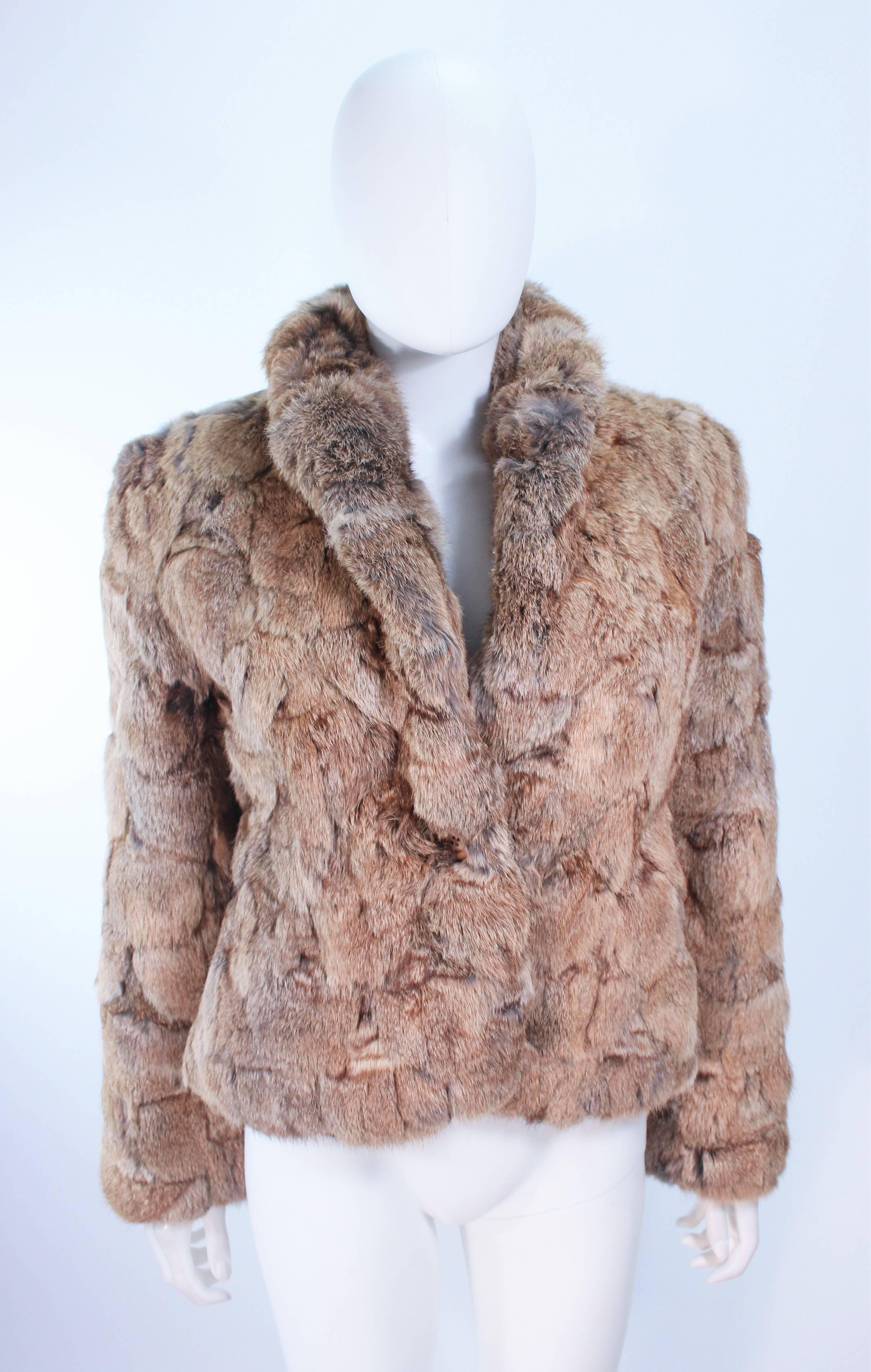 This Sergio Valente jacket is composed of a neutral hue rabbit fur. Features a center front hook and eye closure with side pockets. In excellent vintage condition.

**Please cross-reference measurements for personal accuracy. Size in description