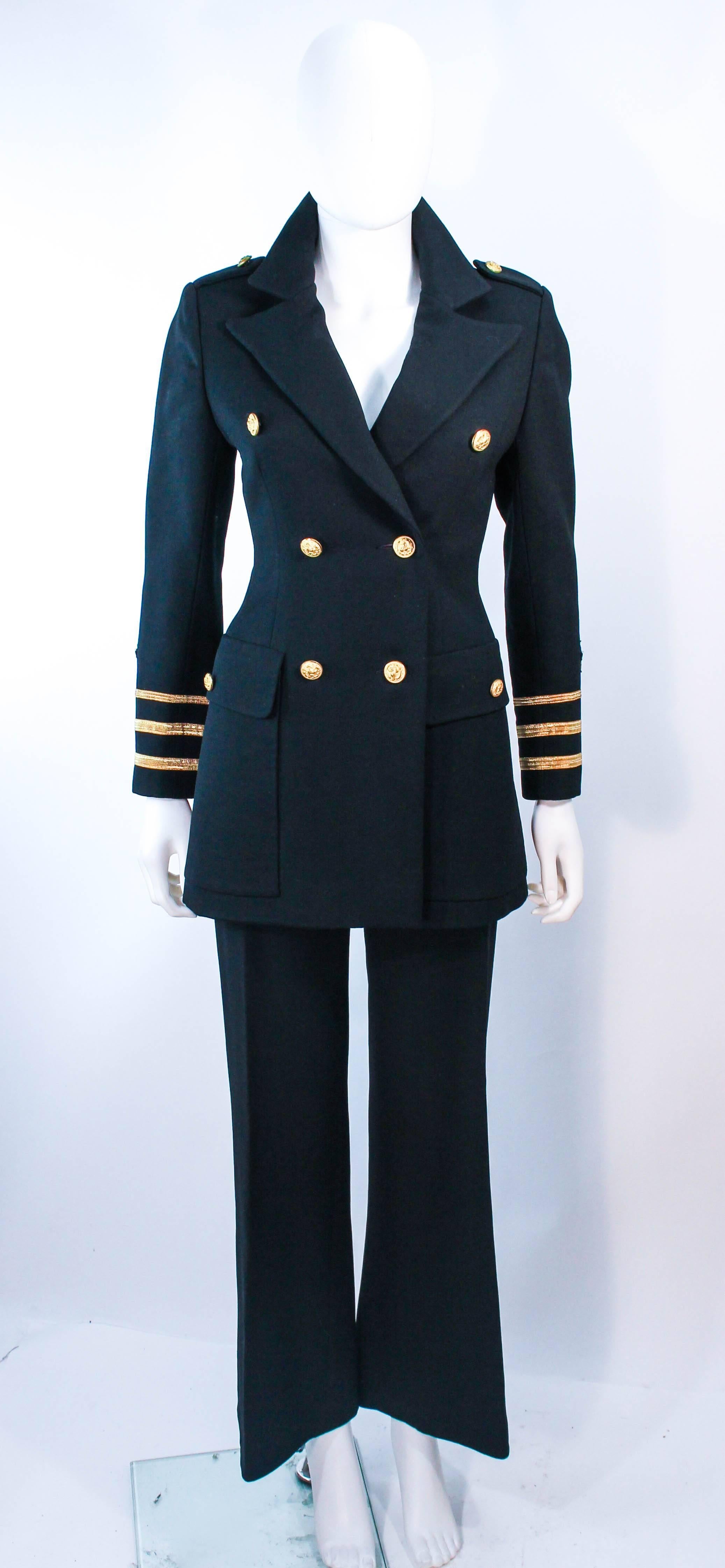 This Gunter Project pant suit is composed of black wool and features gold patch appliques. The jacket has center front button closures and the wide fit slacks have front gold button closures as well. In excellent vintage condition.

**Please